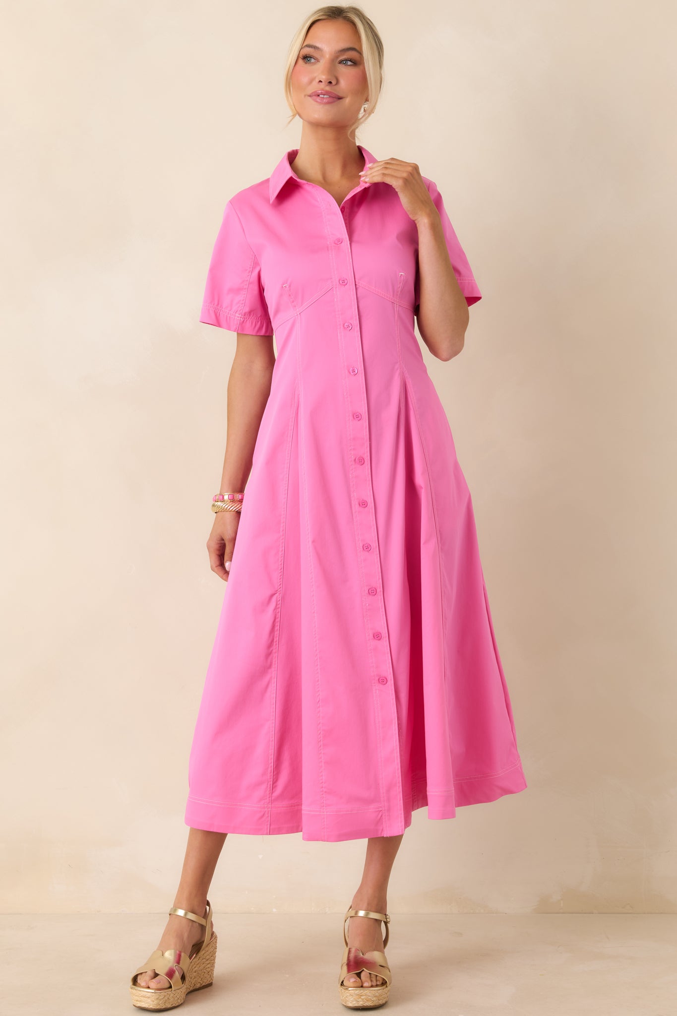 Collared midi dress with short sleeves, flattering seams, and relaxed yet structured shape.