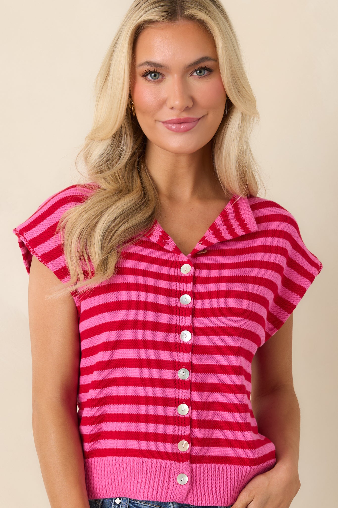 Collared neckline detail with button-front closure on striped top.