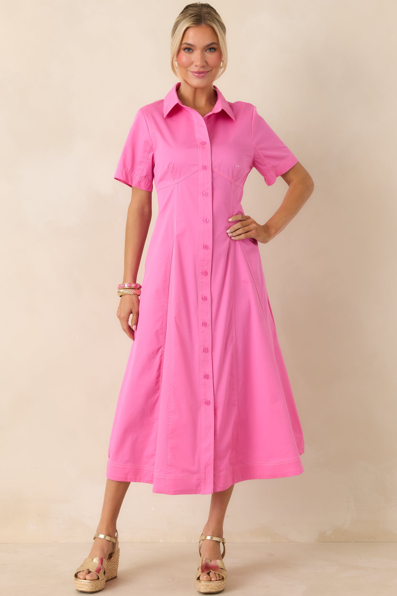 Collared, short-sleeve midi dress with full button front and lightly tailored fit.