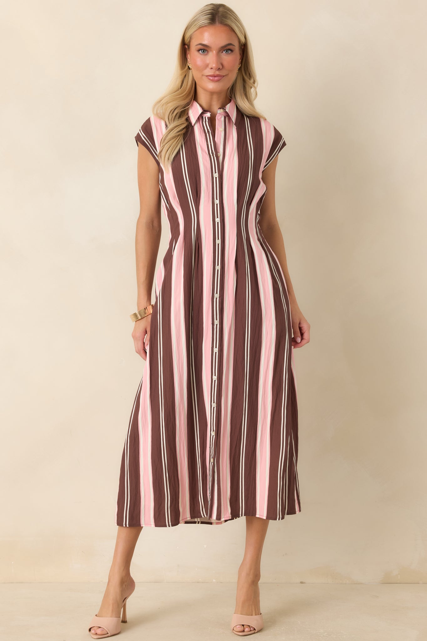 Elegant striped midi dress featuring a collared neckline, structured seams, side pockets, and soft lightweight fabric.
