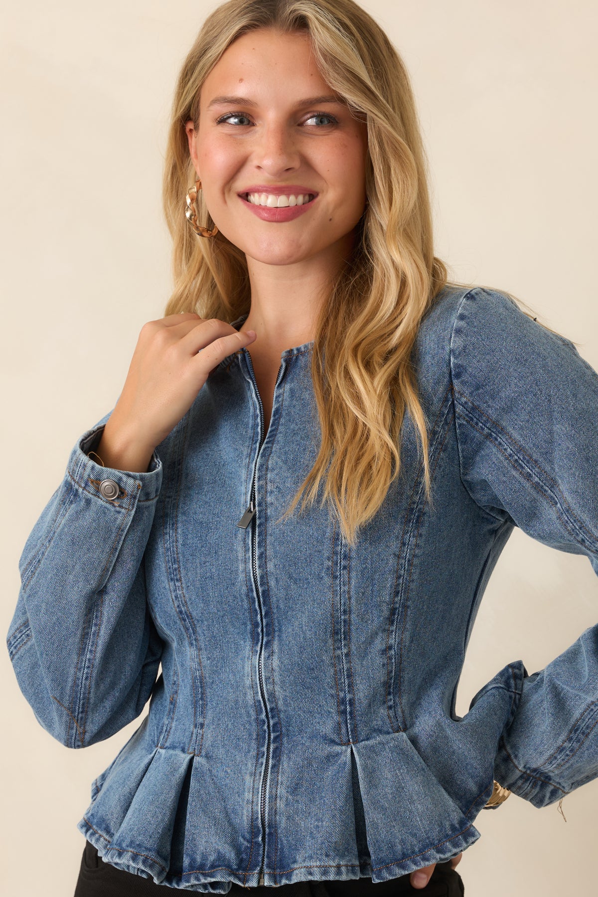 Collarless jacket showcasing its structured front and fitted silhouette.