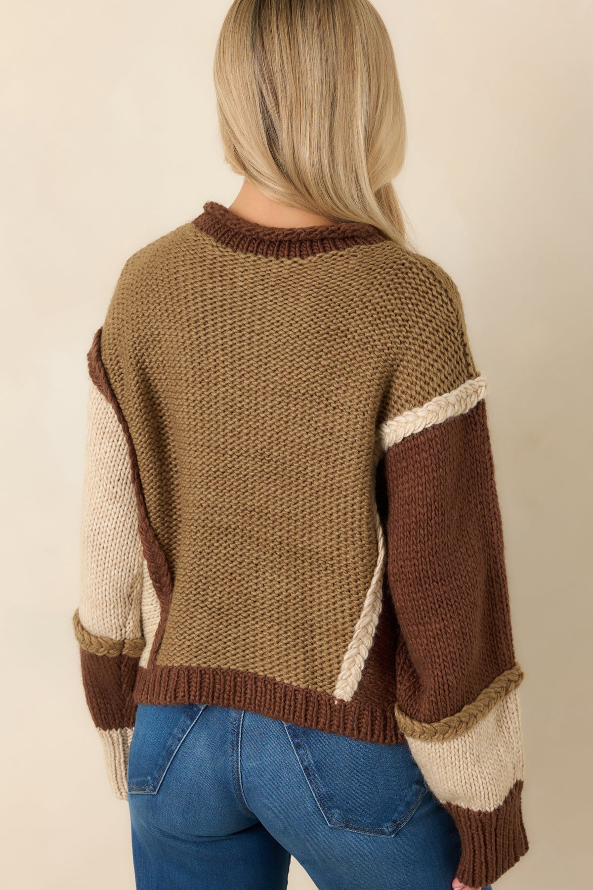 Color-block knit pullover with contrasting back panels, dropped shoulders, long sleeves, and a chocolate brown ribbed hem.