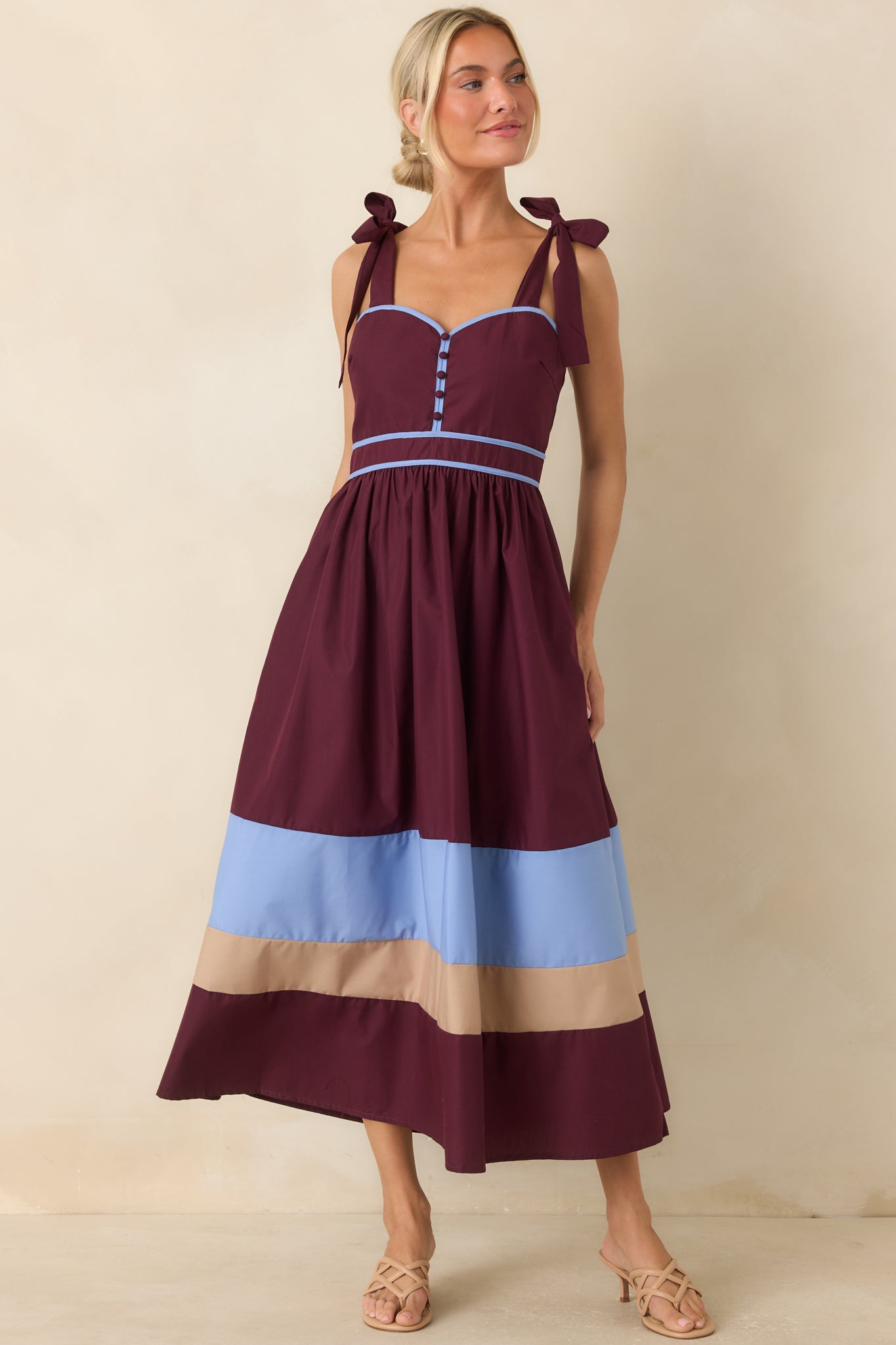 Color-blocked midi dress with a feminine sweetheart neckline, contrast piping, gathered skirt, and hidden side pockets.