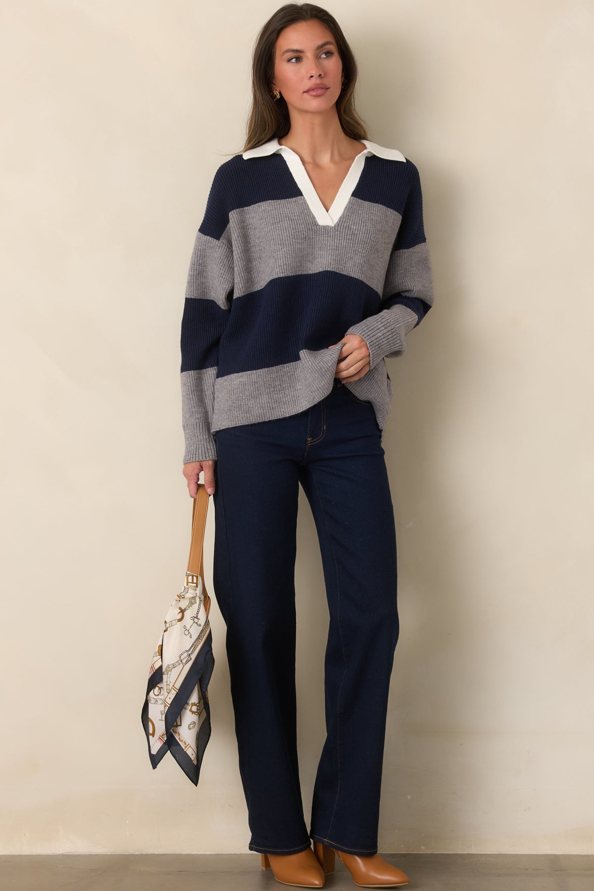 Color-blocked ribbed knit top with broad navy and gray stripes and long sleeves.