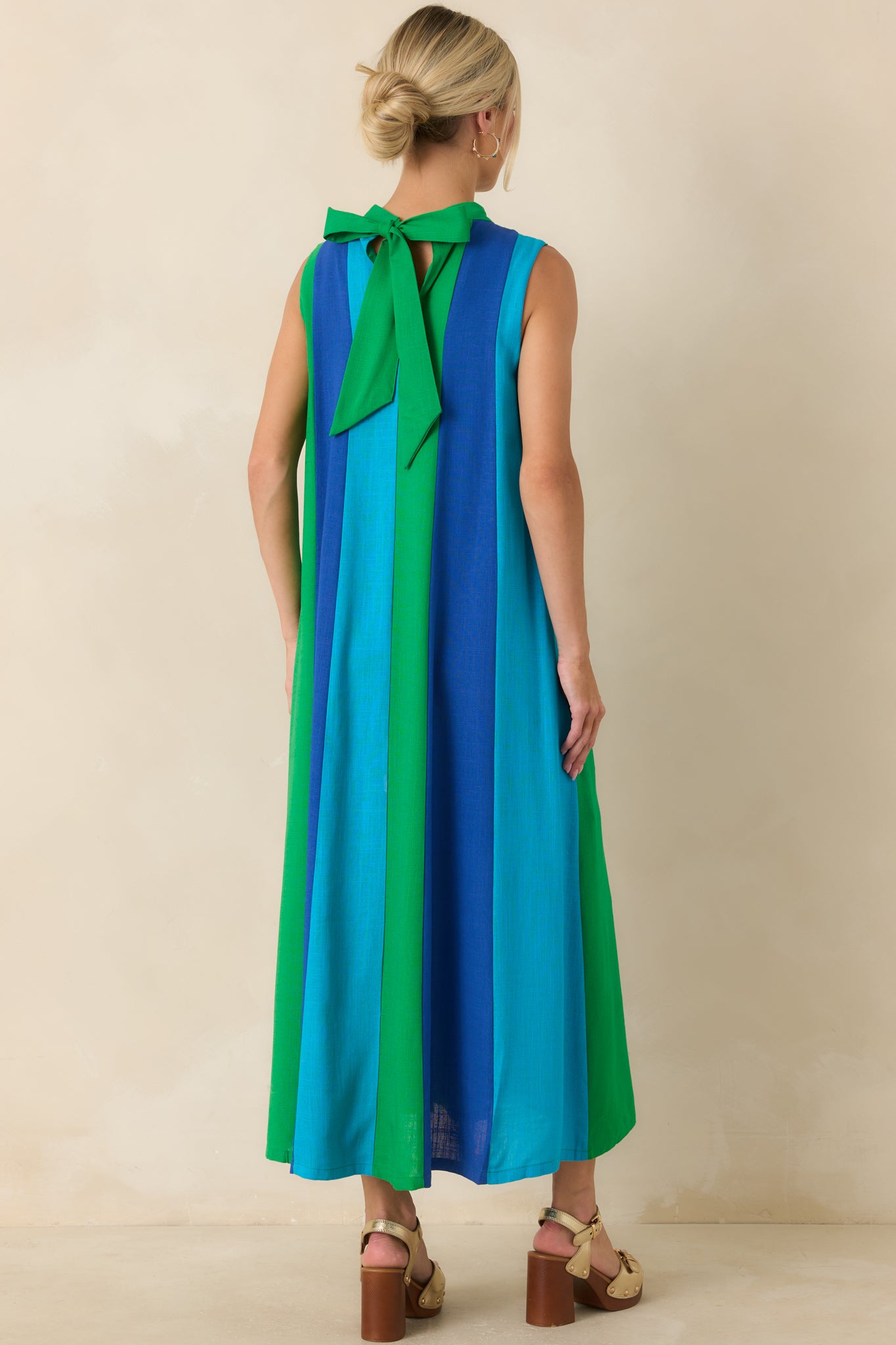 Back view of the colorblock midi dress featuring a tie-back neckline with an elegant bow detail.