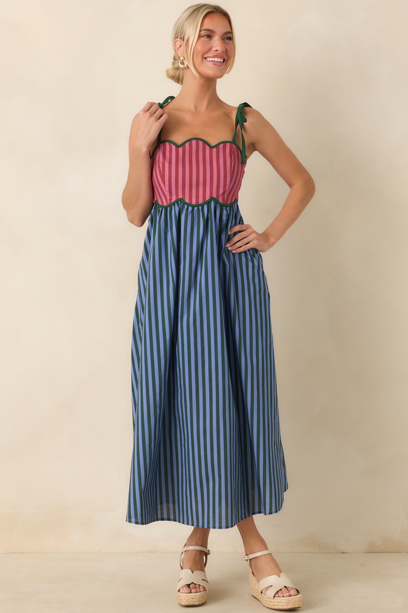 Colorful cotton midi dress with blue stripes, green accents, tie shoulder straps, and a flattering silhouette.