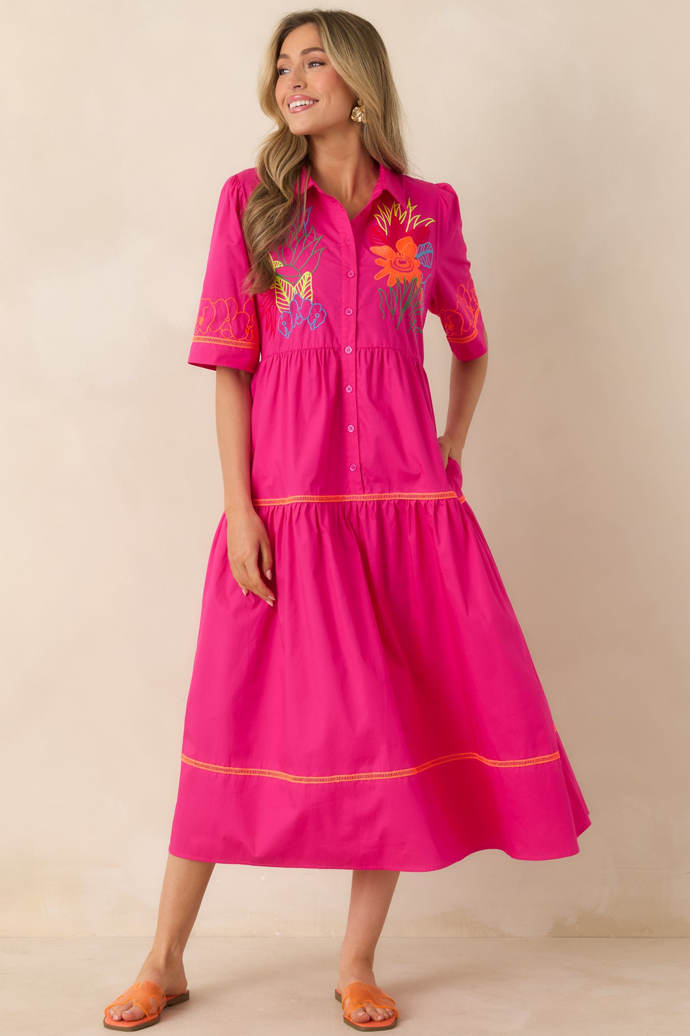 Colorful dress with collared neckline, flowing tiers, and lightweight silhouette.