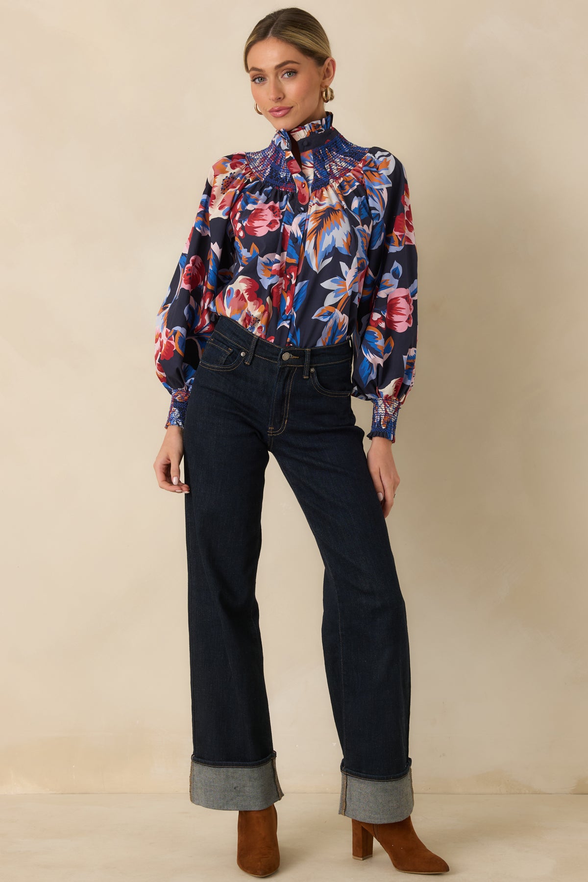 Colorful floral cotton top with fabric-covered buttons, a defined ruffled neckline, and voluminous blouson sleeves.
