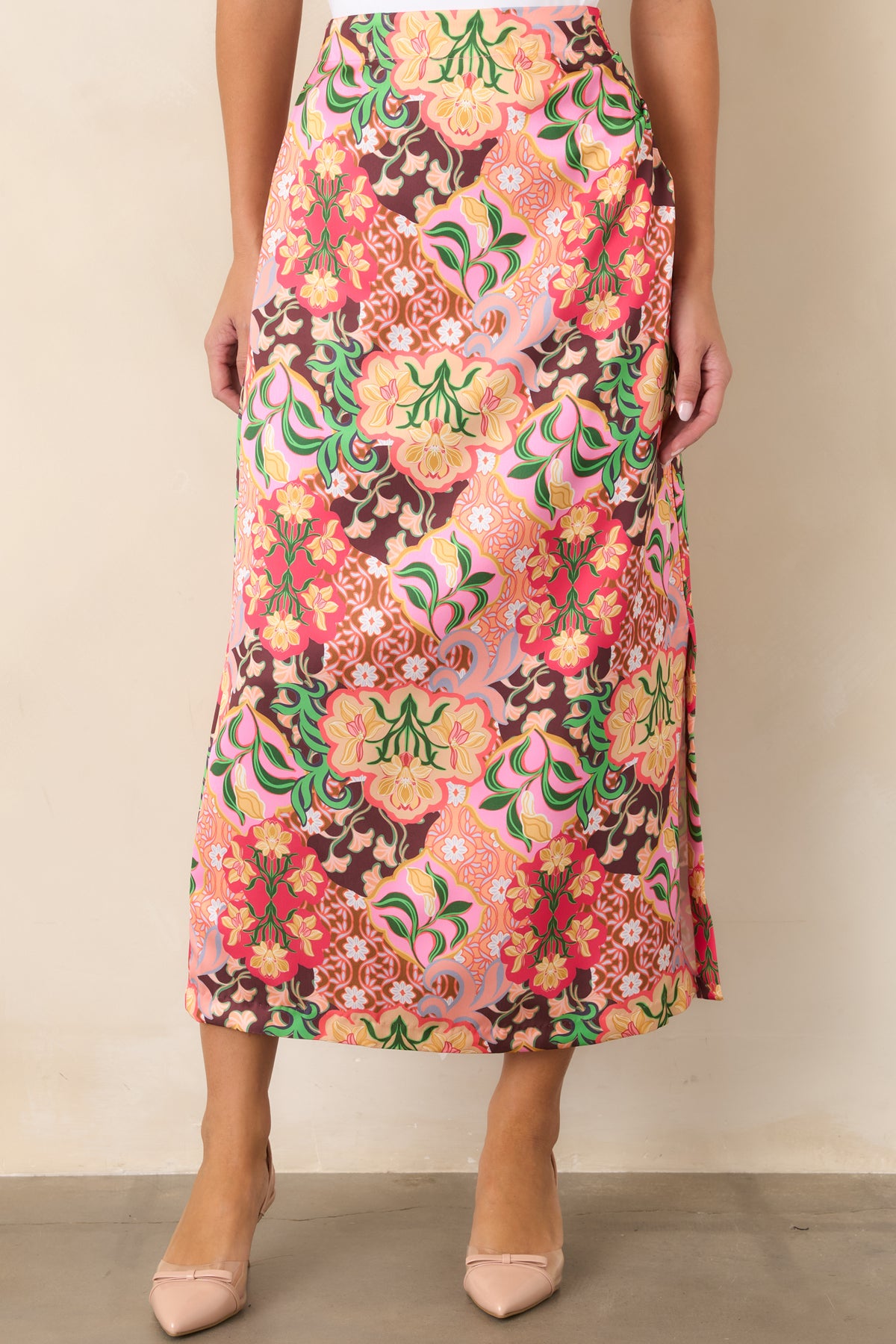 Gently flared skirt showcasing the colorful floral print and neatly finished midi hem.
