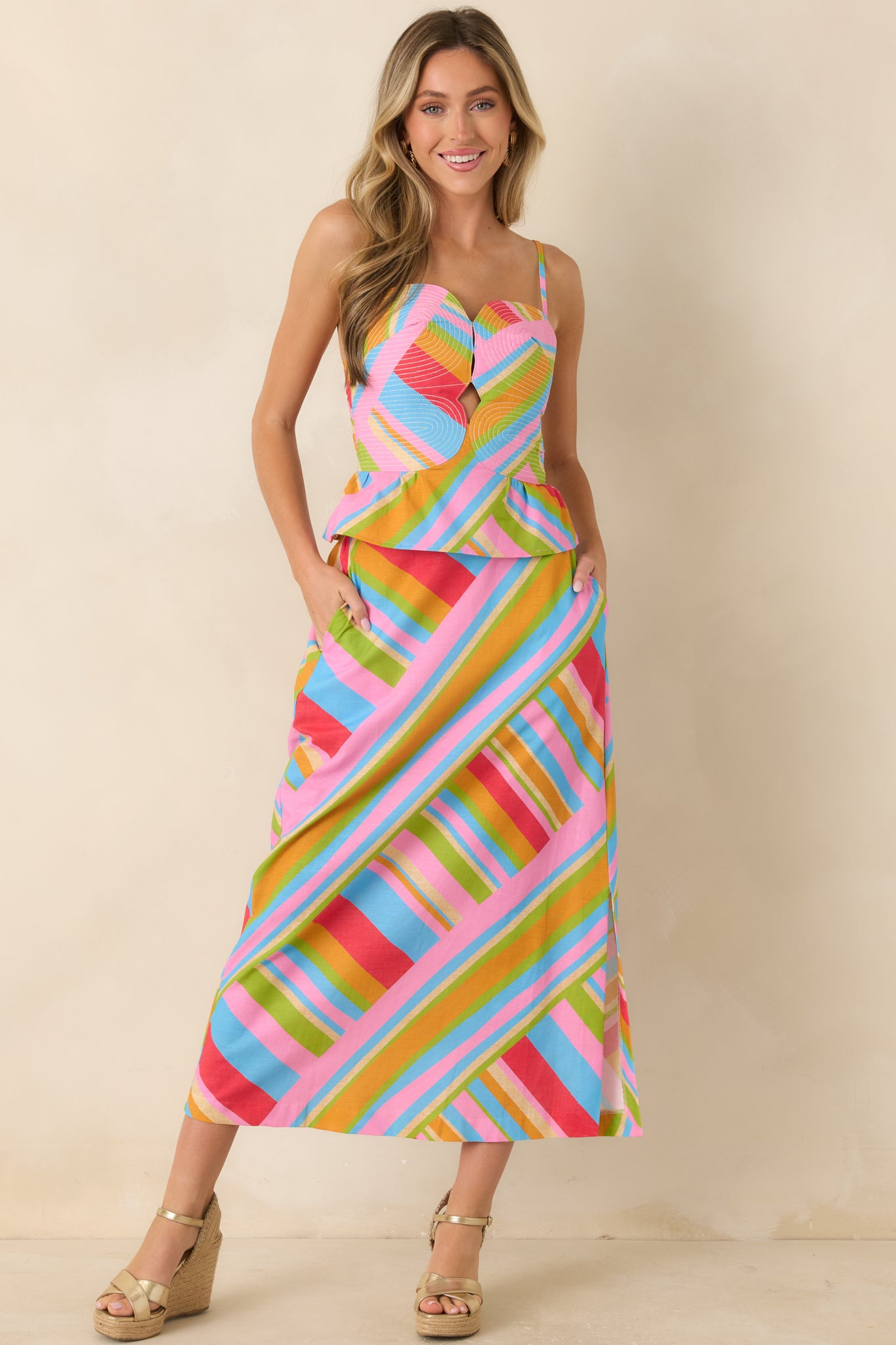 Vibrant printed midi skirt with pink, blue, green, and orange tones, designed with an A-line shape and comfortable waistband.