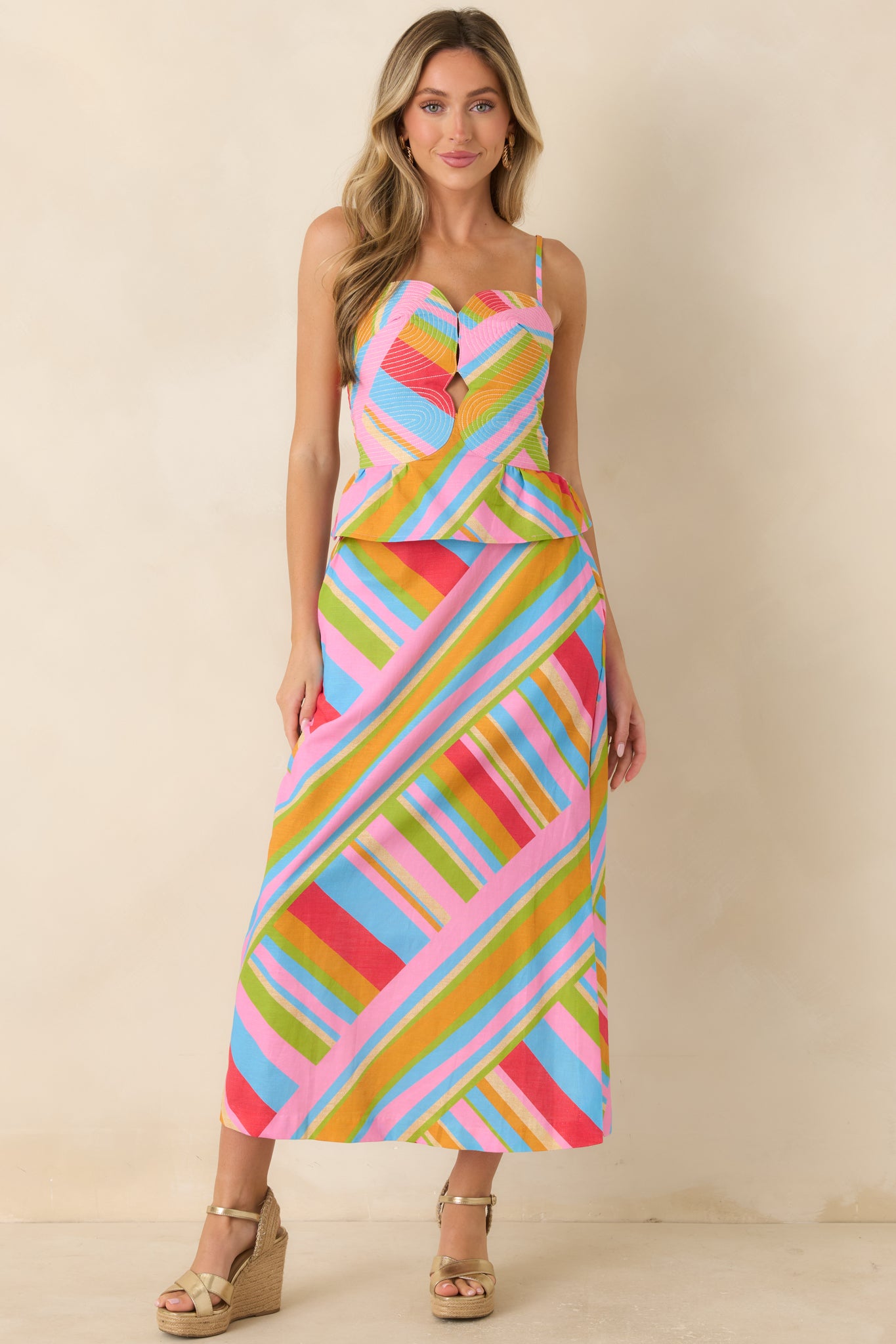 Colorful cotton linen top showcasing a bold geometric print, structured bodice, flattering peplum silhouette, and adjustable shoulder straps.