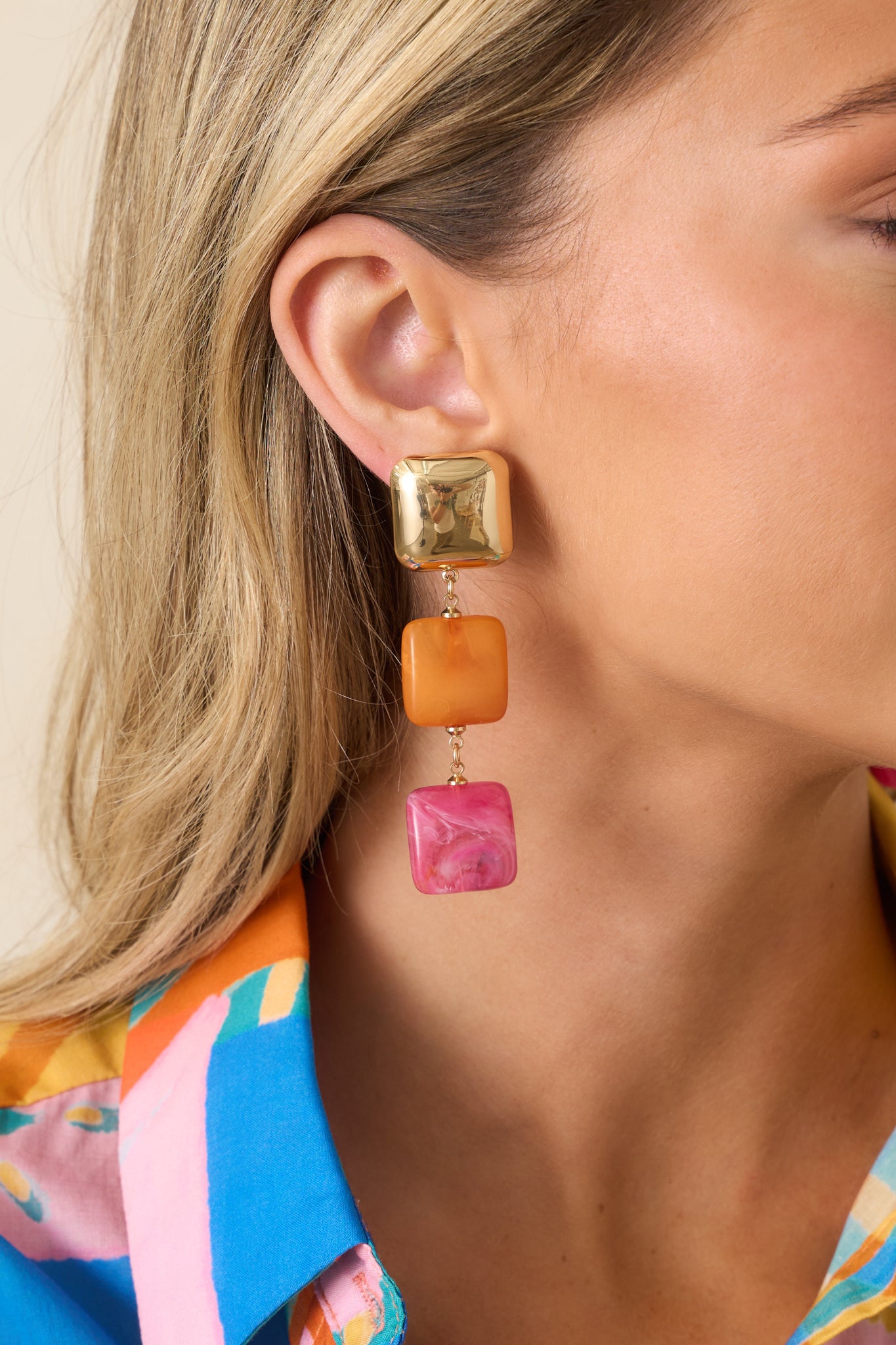 Statement earrings showcasing layered geometric squares, vibrant colors, and a lightweight dangling silhouette.