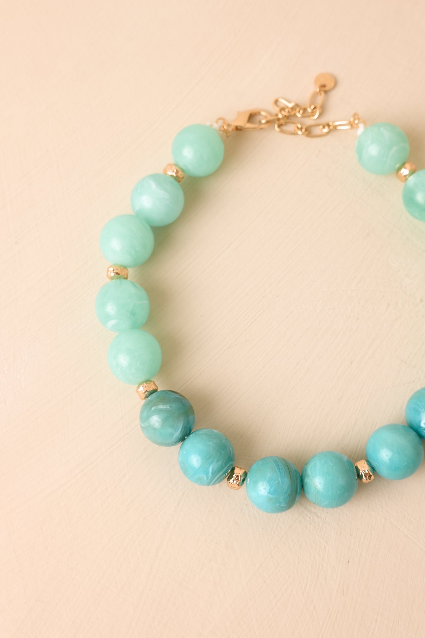 Colorful statement necklace featuring chunky marbled beads and an adjustable extender chain.