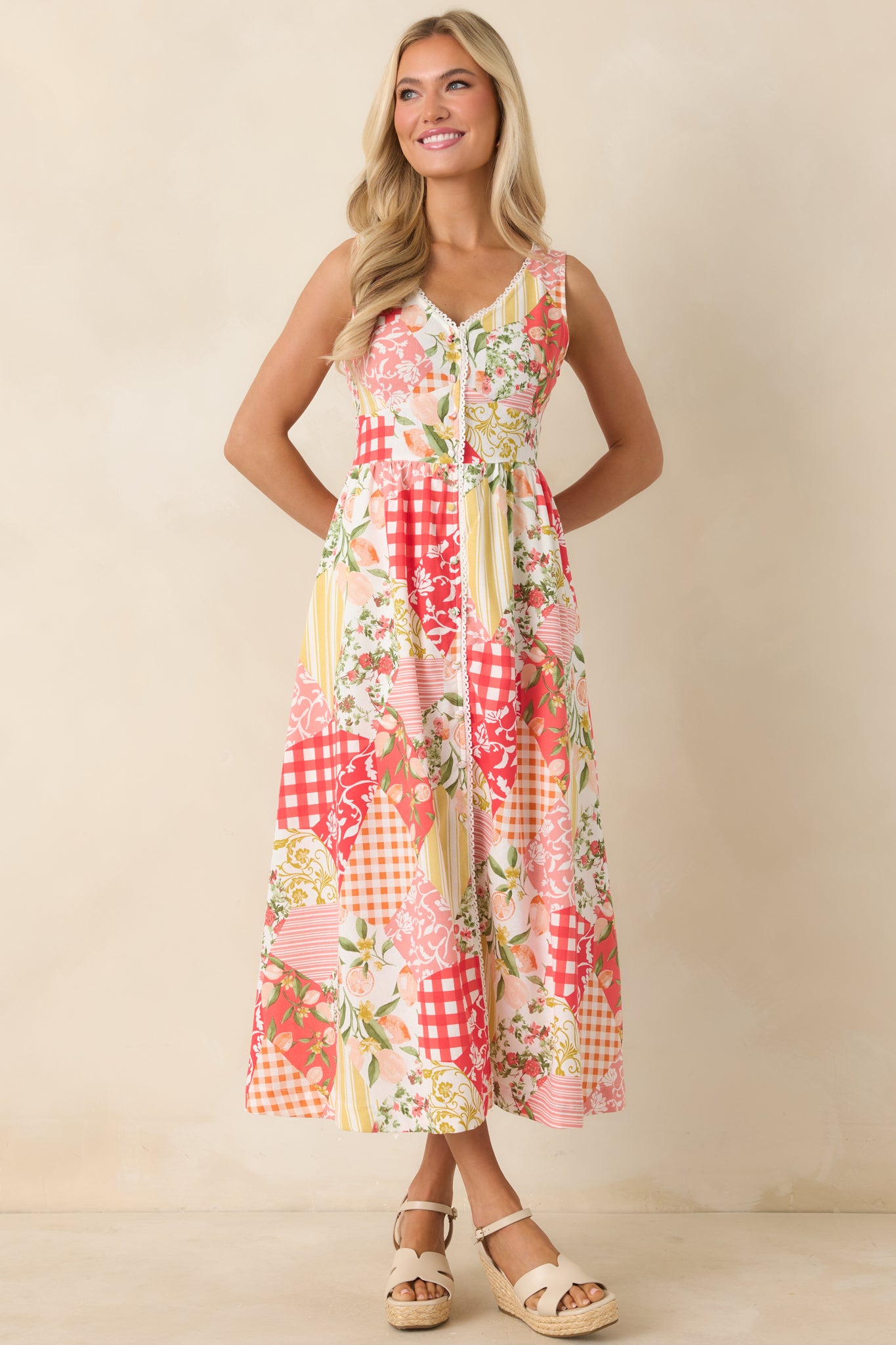 Colorful mixed print midi dress with a structured top, soft skirt, and charming vintage-inspired details.