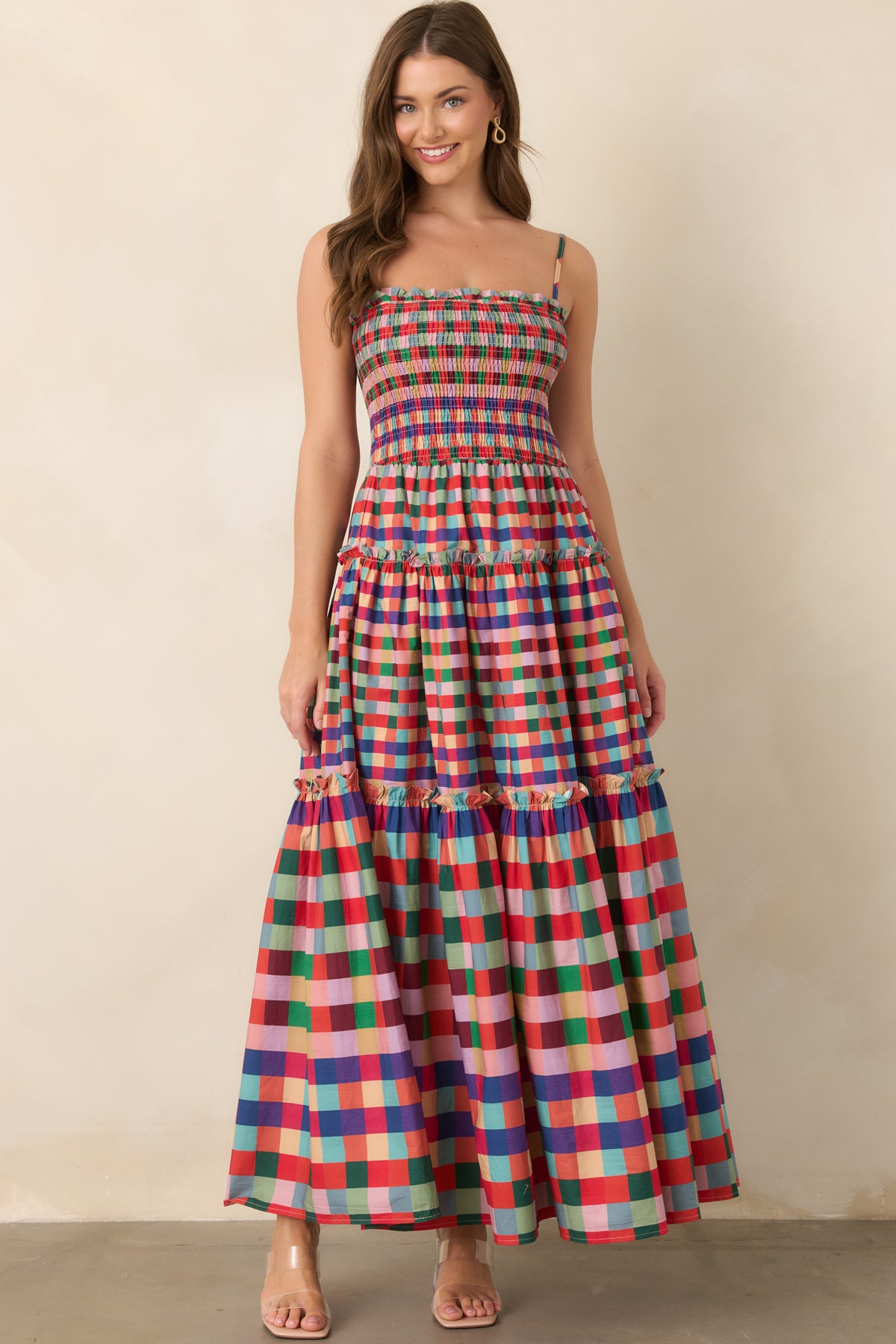 Colorful plaid maxi dress with a playful tiered silhouette and ruffled neckline.
