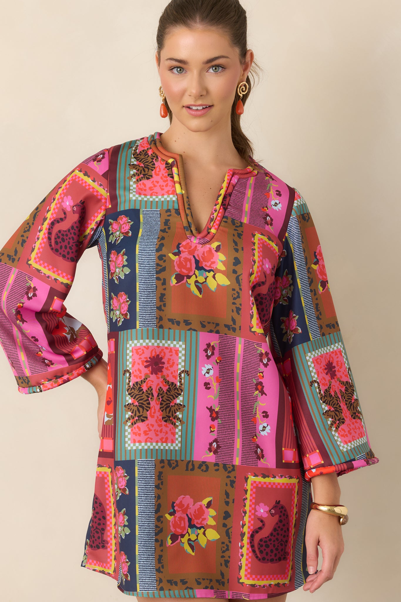 Printed poly twill dress showcasing the vibrant motif, three-quarter sleeves, and contrasting corded edging along the neckline and sleeve openings.