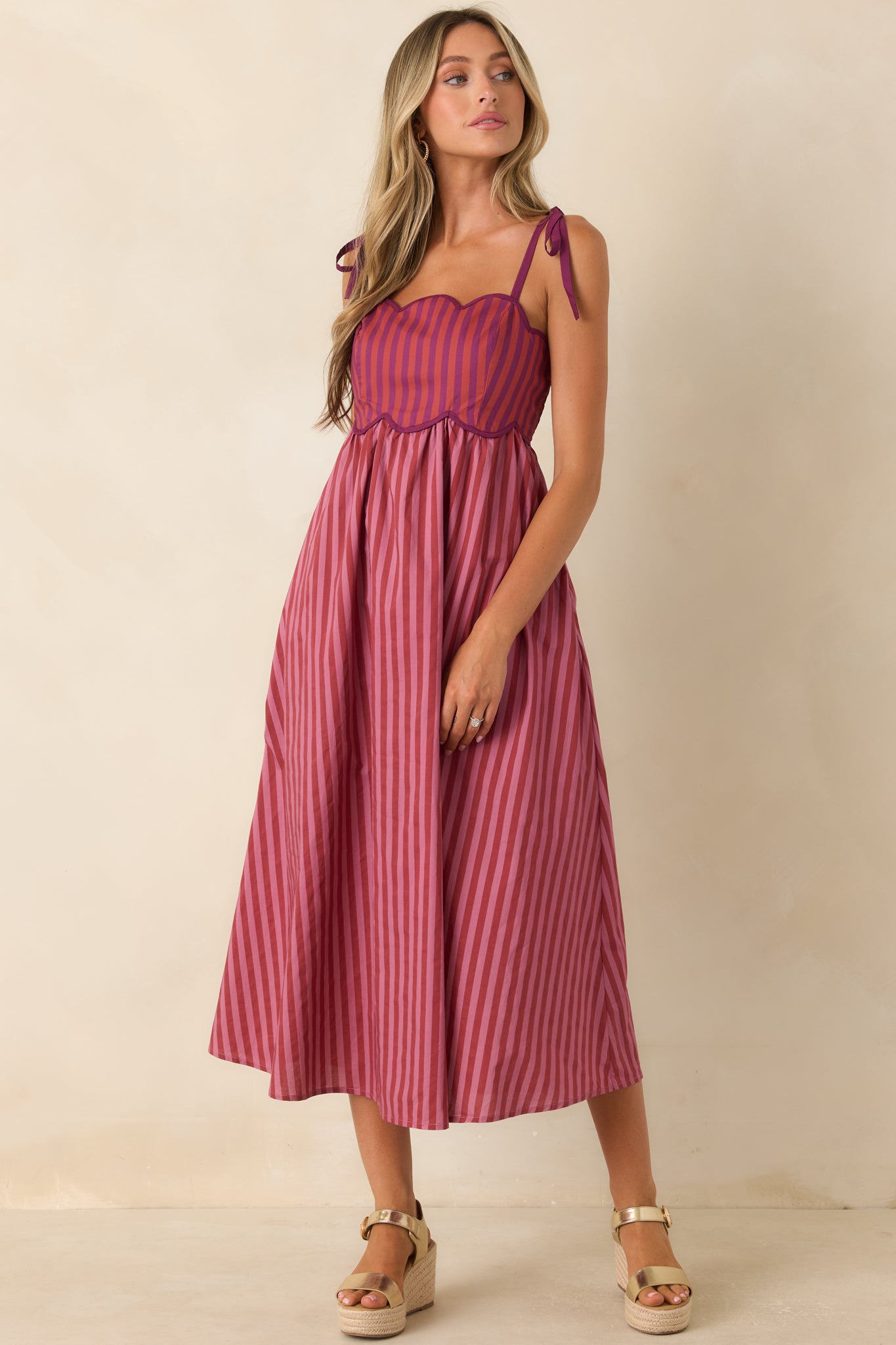 Whimsical midi dress with colorful striped panels, tie straps, and hidden side pockets.