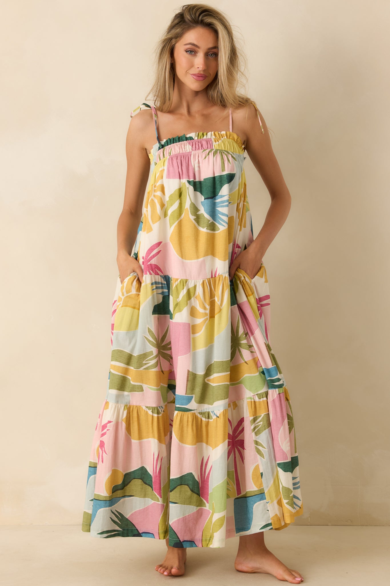 Colorful tropical print maxi dress with a relaxed bodice, gathered neckline, and sweeping tiered silhouette designed for effortless movement.