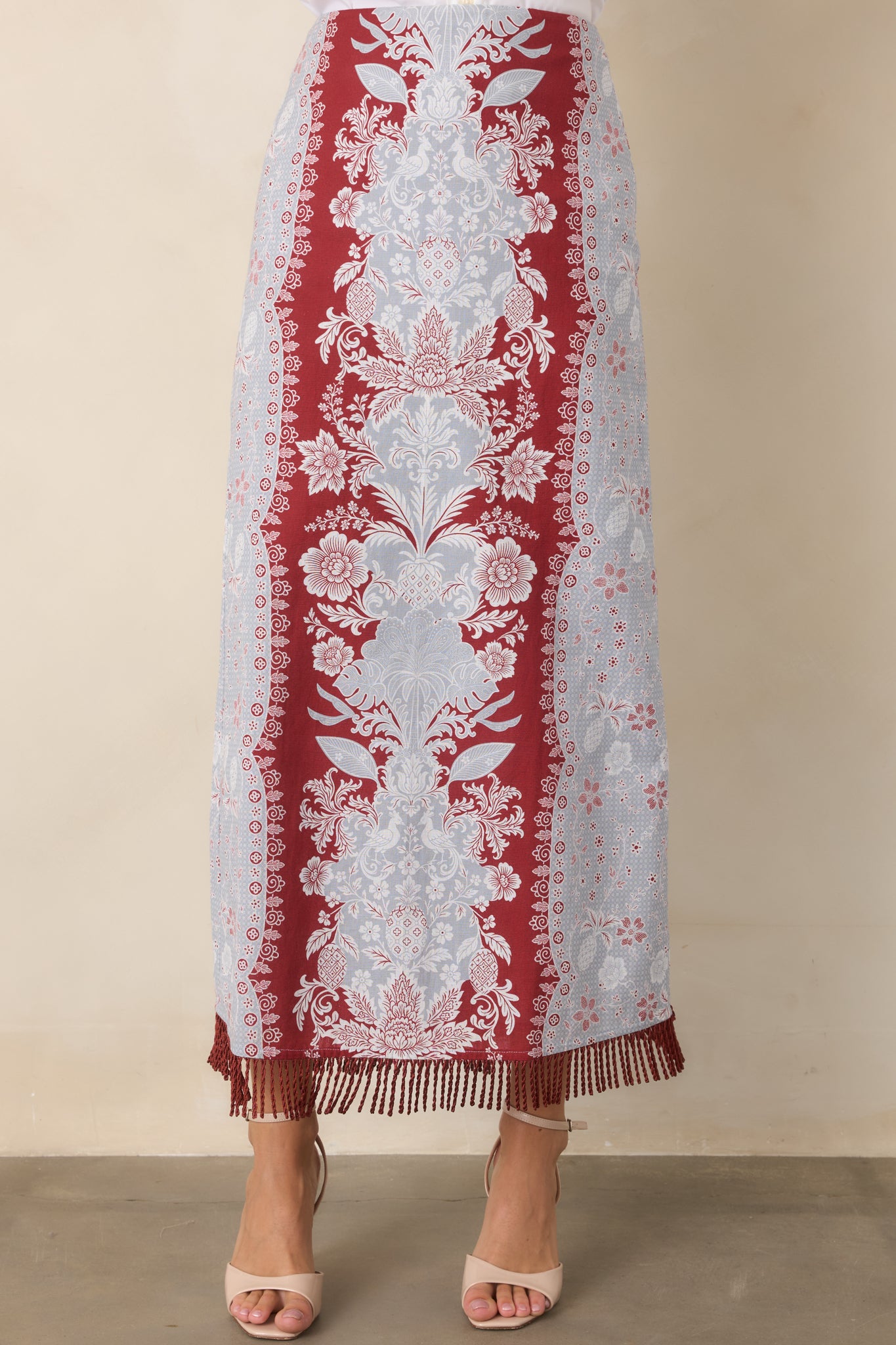 Column-style silhouette extends into a long skirt finished with a distinctive fringe-trimmed hem.