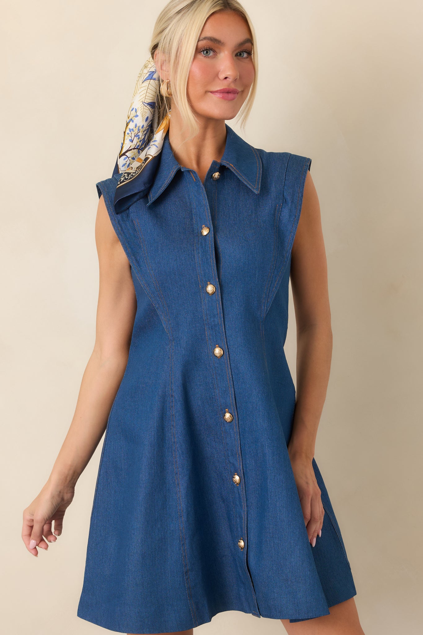 Upper portion of the sleeveless dress showcasing the contoured bodice seams, pointed collar, and polished button-front design.