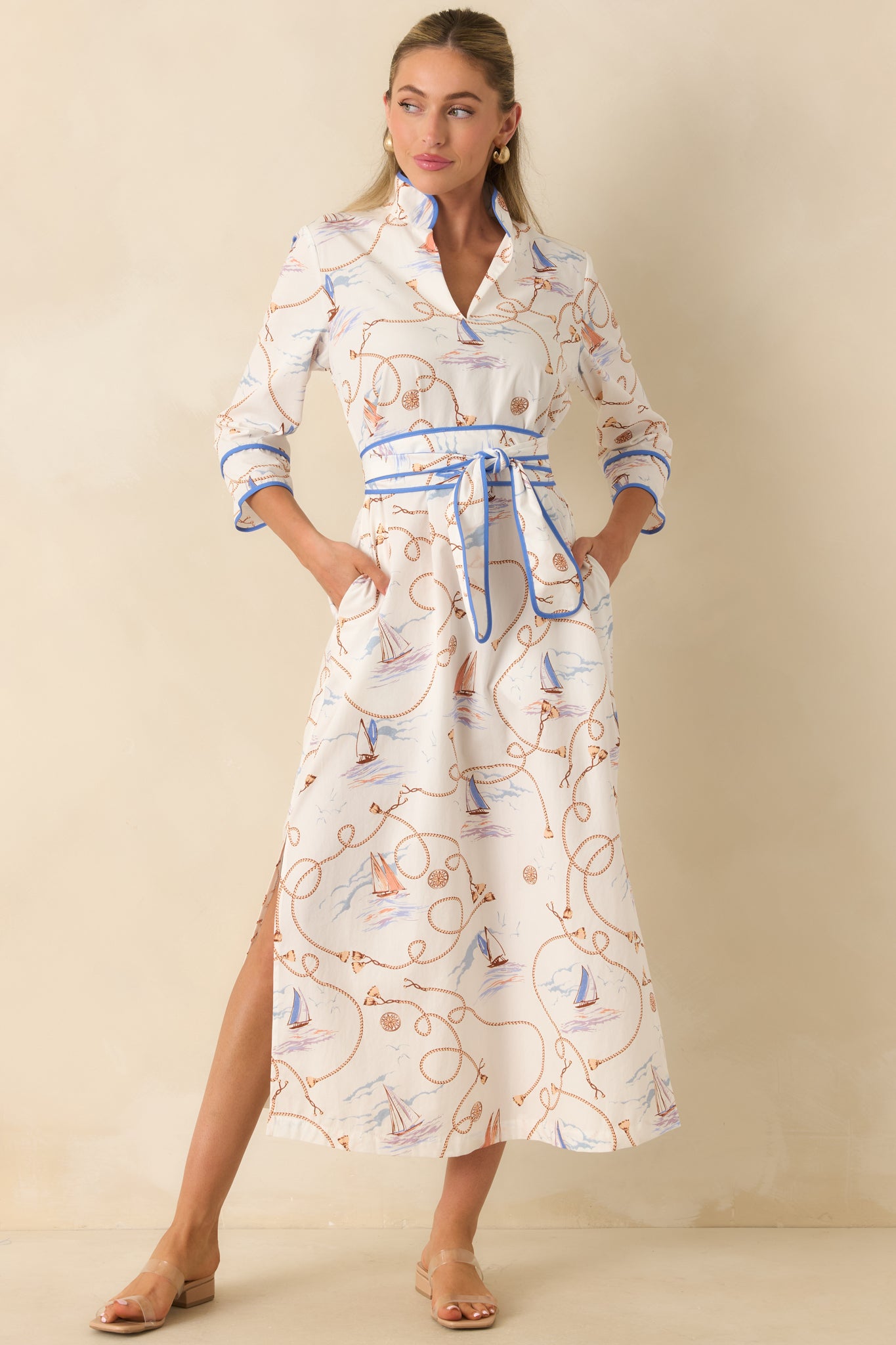 Breathable cotton dress designed with contrast piping throughout, a defined waist, and an elegant full-length silhouette.