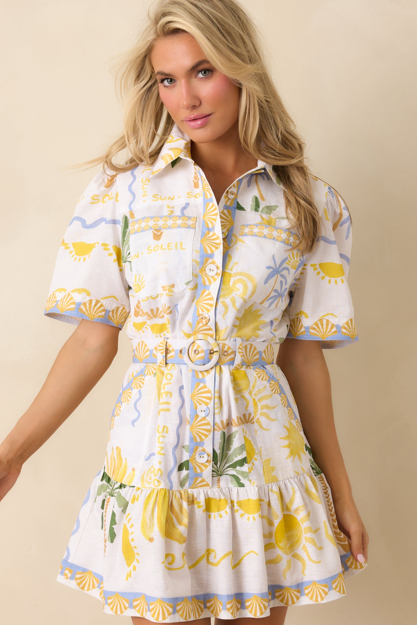 Coordinating belt cinching waist for a defined, feminine shape.