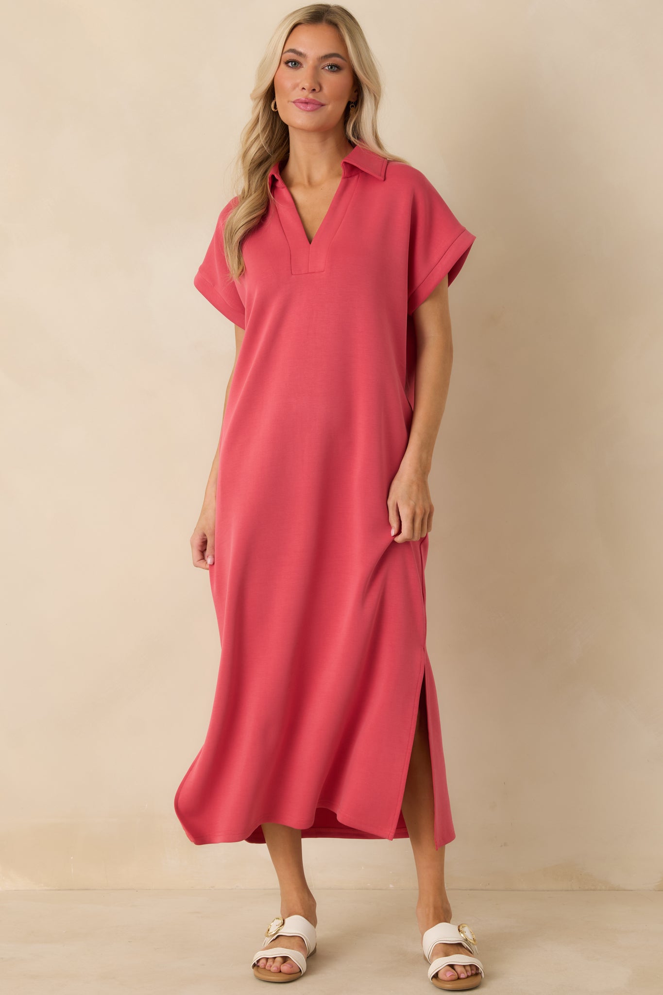 Coral pink mid-length dress designed with short sleeves, functional pockets, and a fluid, comfortable drape.