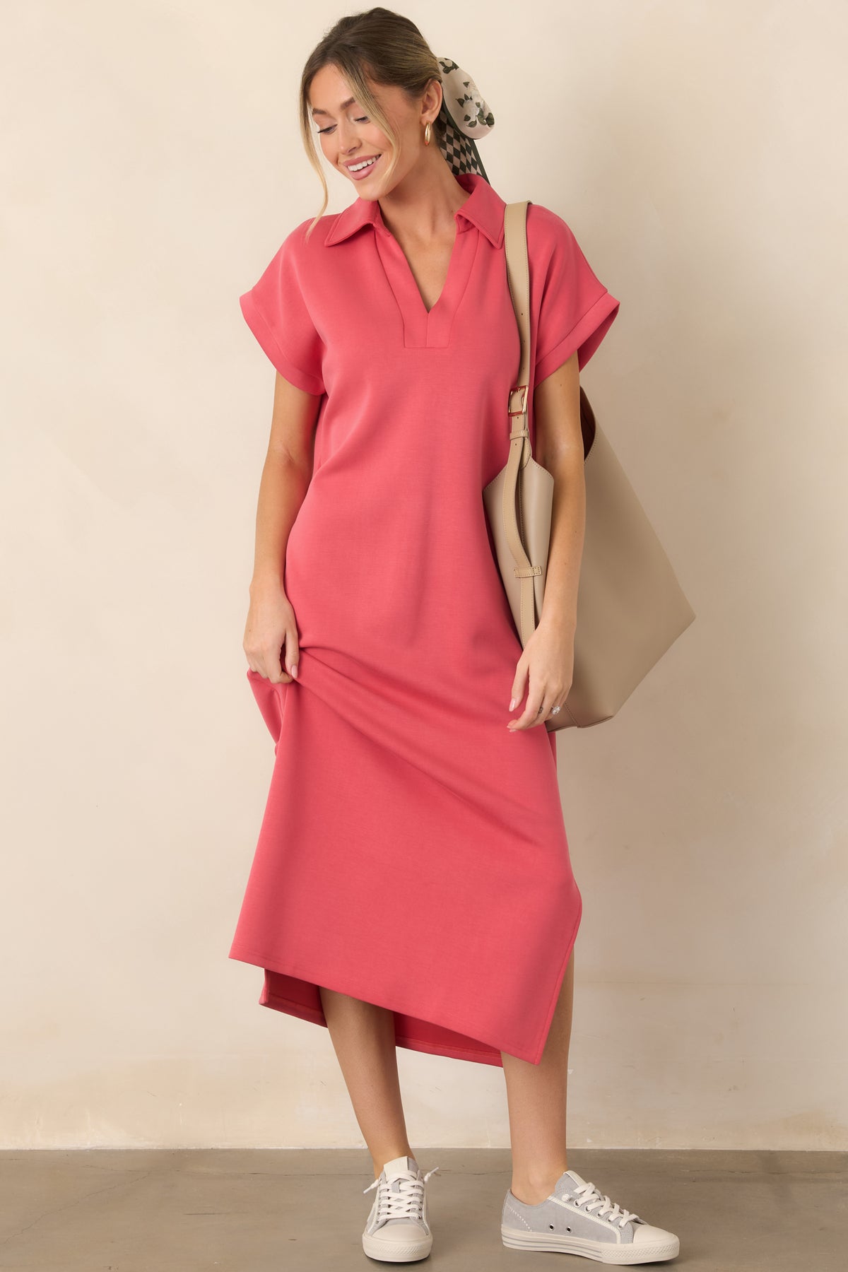 Coral pink midi dress with a collared notch V-neckline, short sleeves, relaxed fit, side vents, and functional pockets.