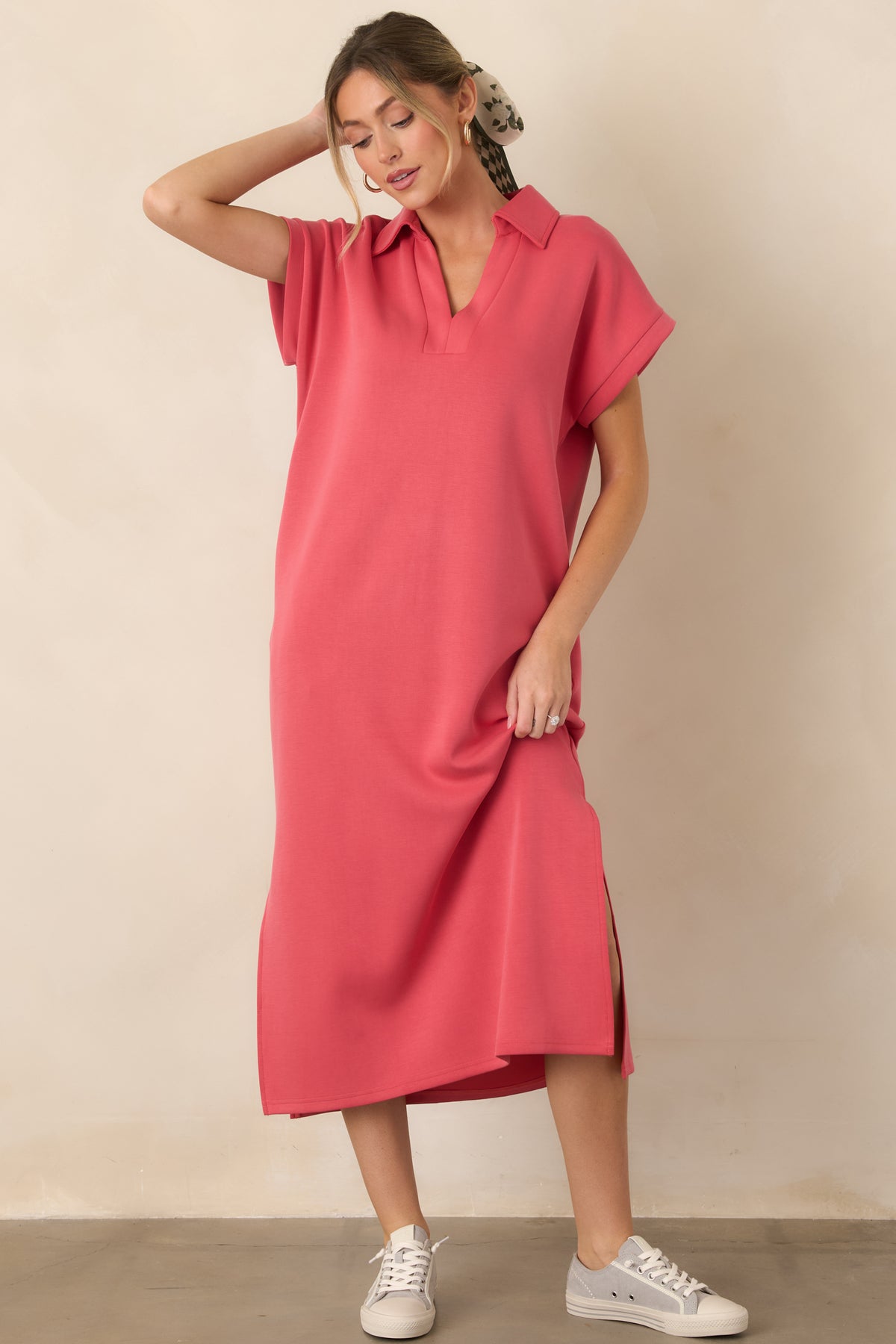 Relaxed coral pink midi dress designed with a collared neckline, short sleeves, functional pockets, and side vents for easy movement.