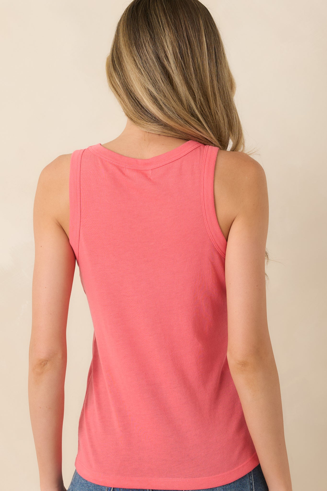Coral sleeveless tank top rear view featuring a clean, fitted silhouette and smooth finish