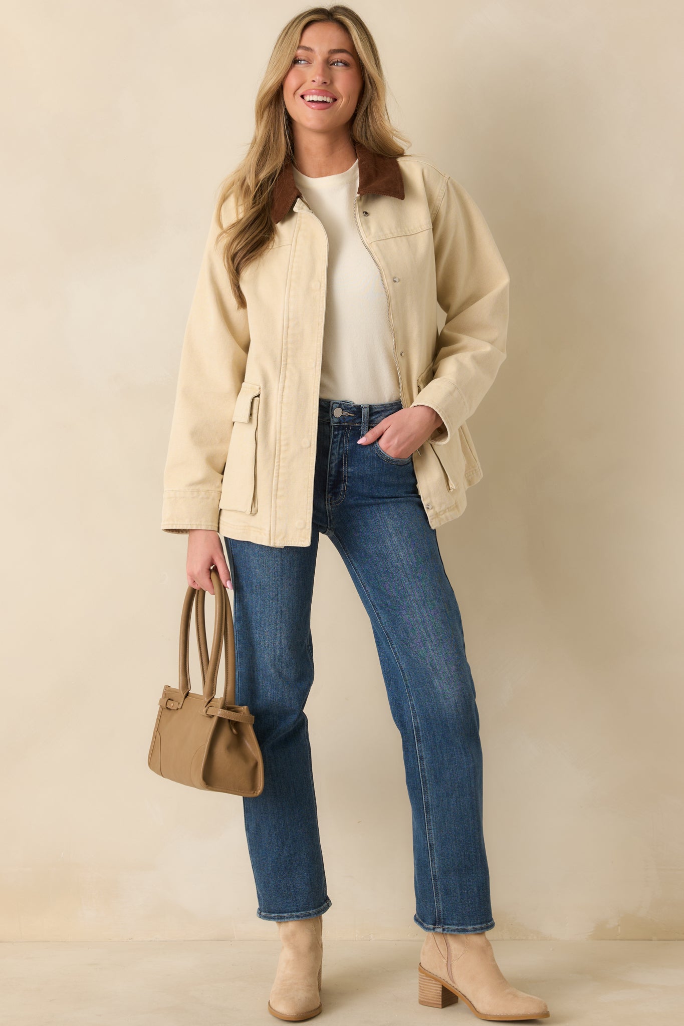 View of the corduroy collar meeting the smooth taupe canvas body.