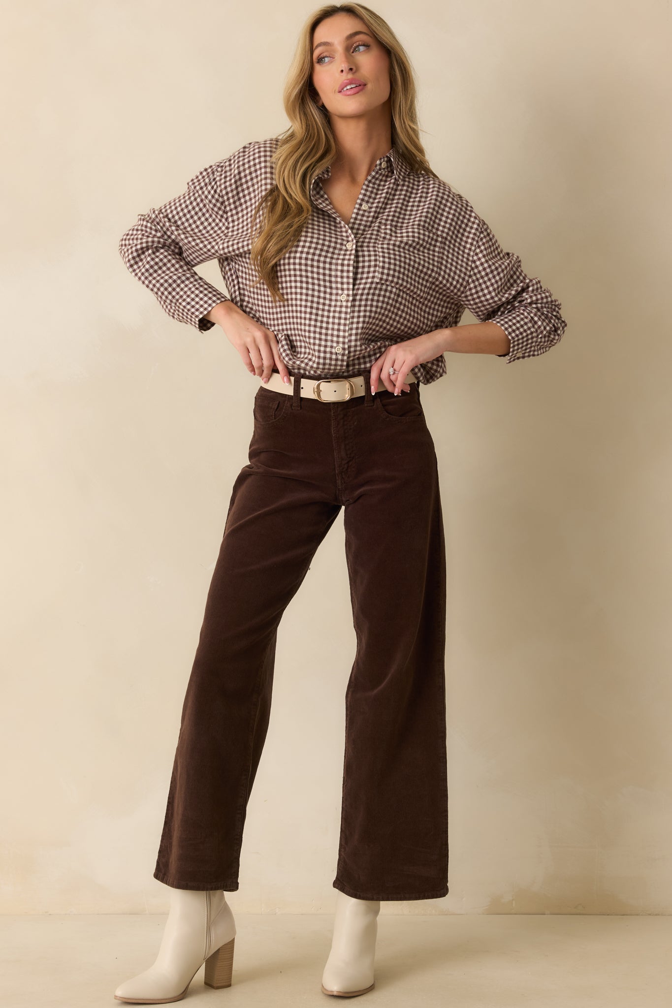 Full body front view showing the relaxed drape and belt loops of the corduroy pants.