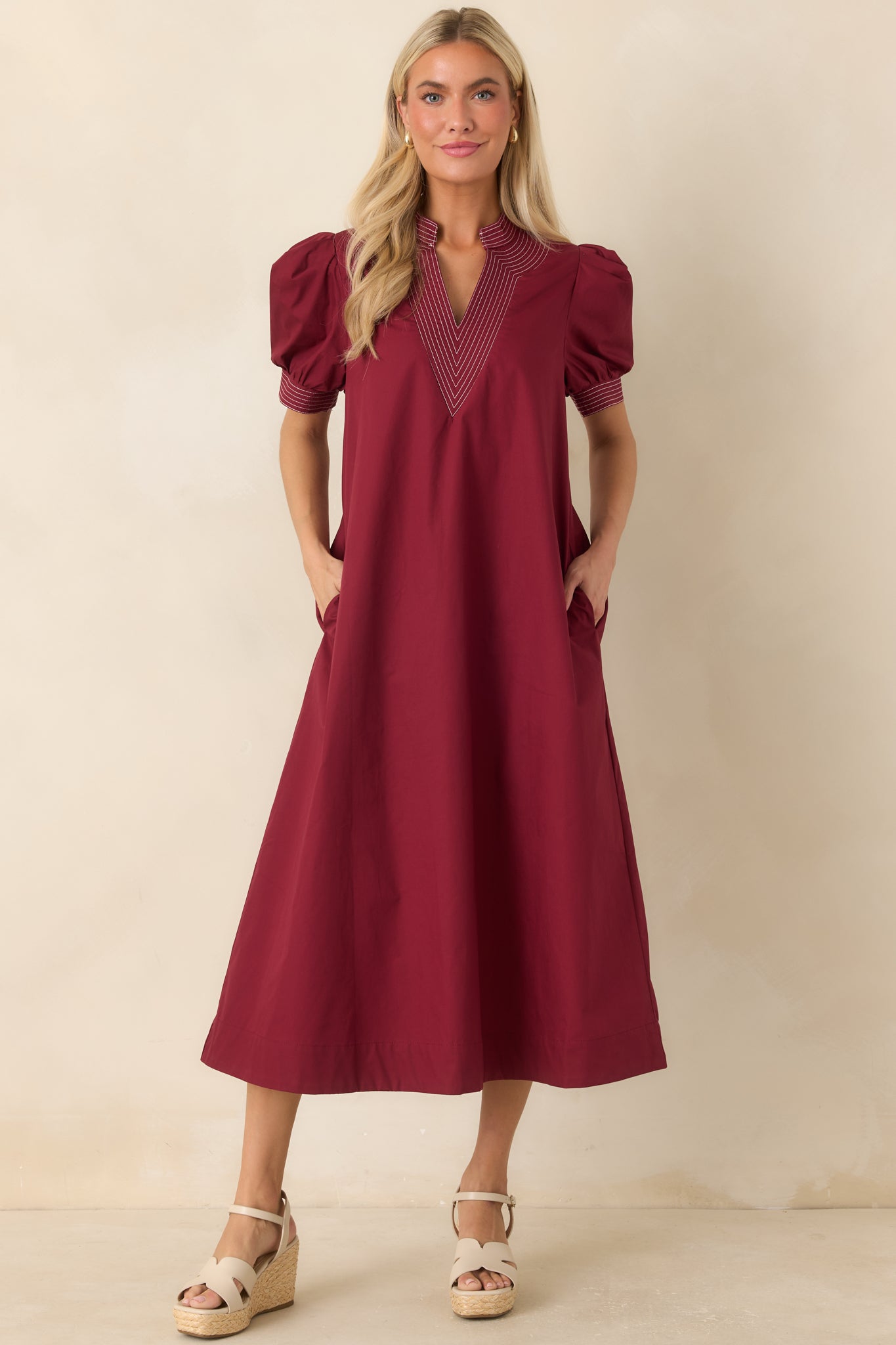 Cotton A-line dress with a rich burgundy hue, stitched sleeve cuffs, and a relaxed midi-length silhouette.