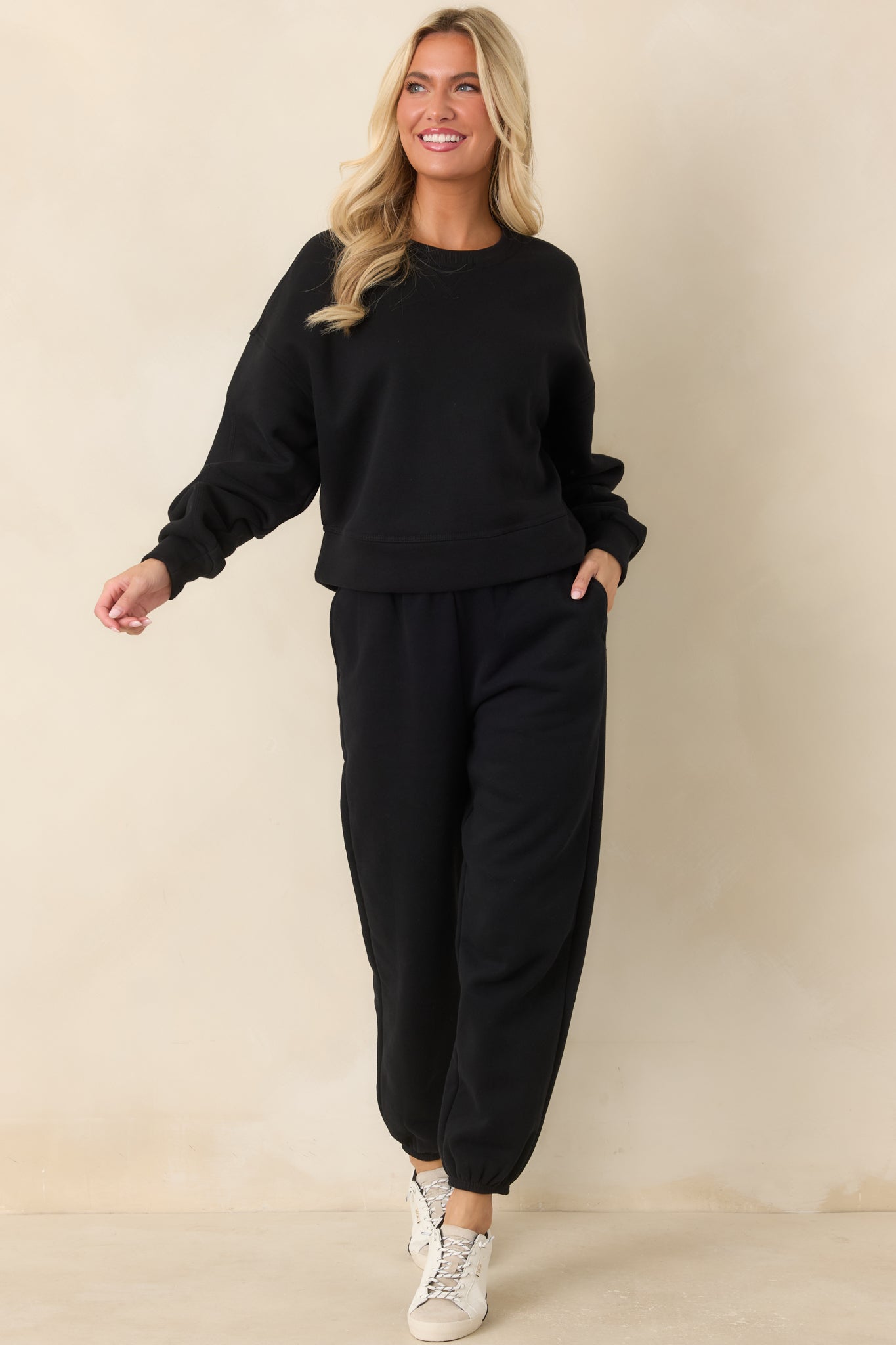 Cotton-blend black joggers showcasing a relaxed tapered fit, ribbed waistband, side pockets, and adjustable drawstring.