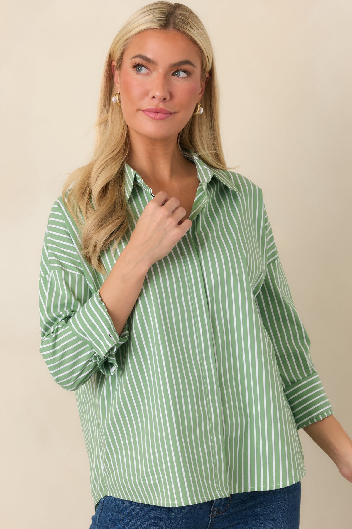 Detailed view of the shirt's button cuff and long sleeve, highlighting its clean tailored construction.