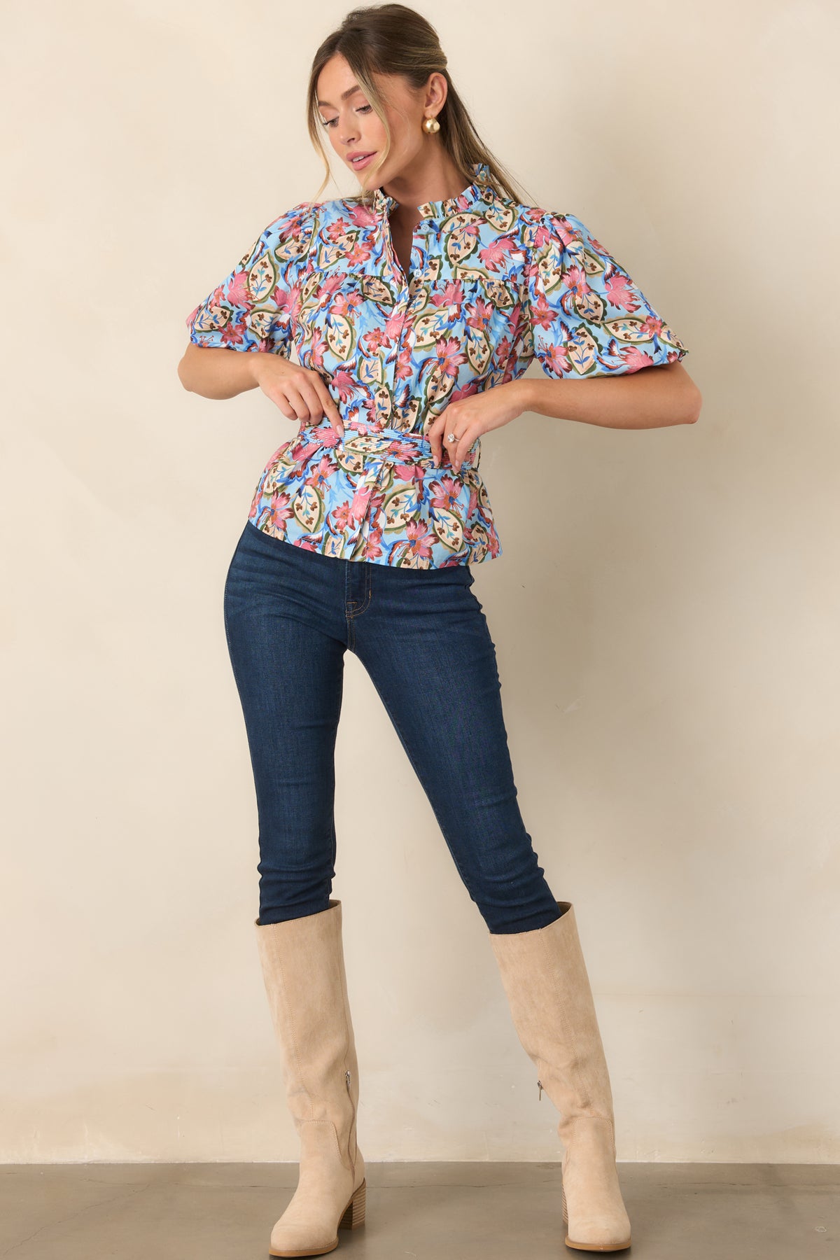 Cotton-blend blouse featuring a button-front closure, short gathered sleeves, and a softly defined waist.