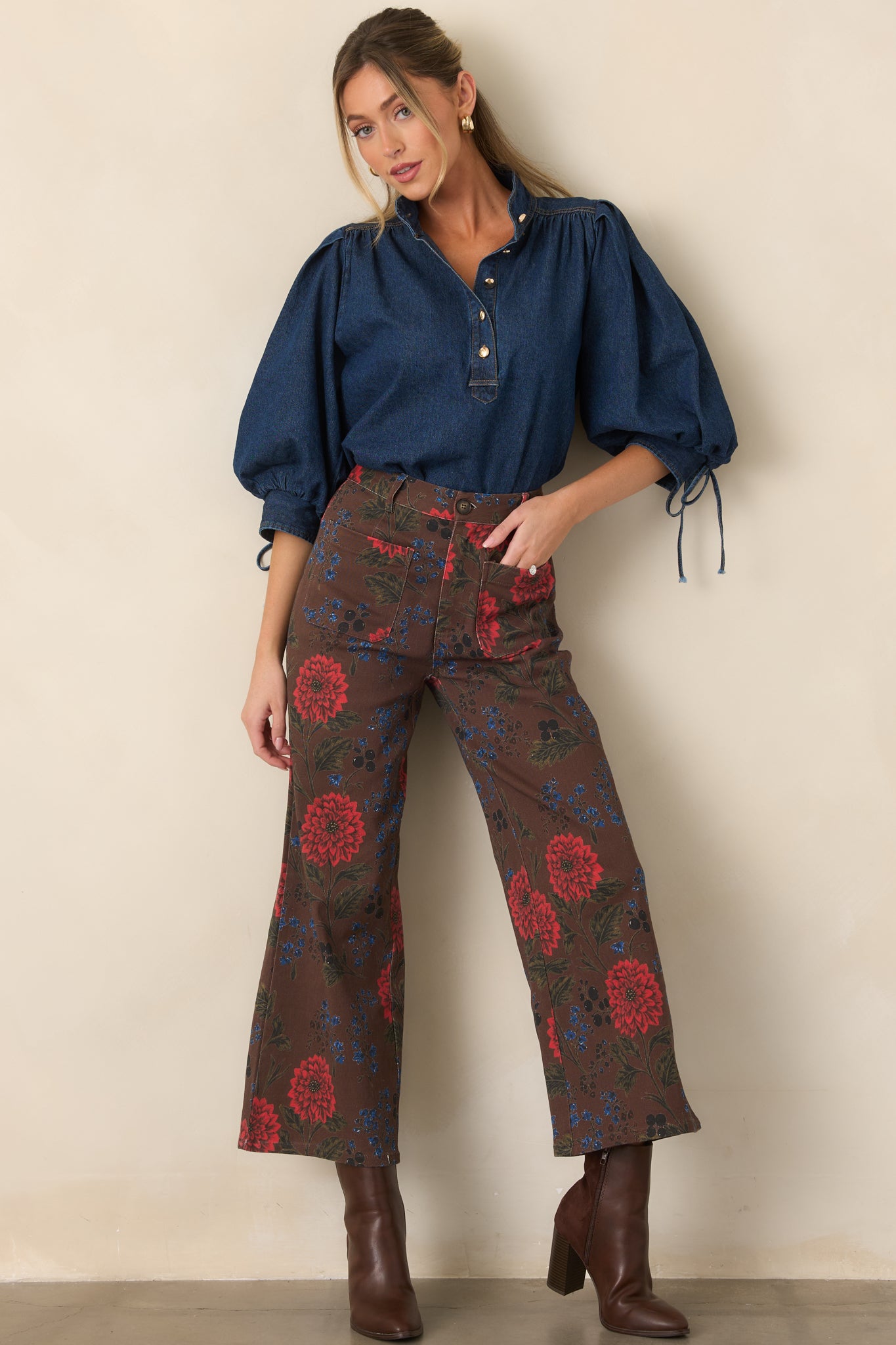 Cotton-blend denim blouse featuring a crisp collar, partial button front, voluminous sleeves, and an effortless draped hem.