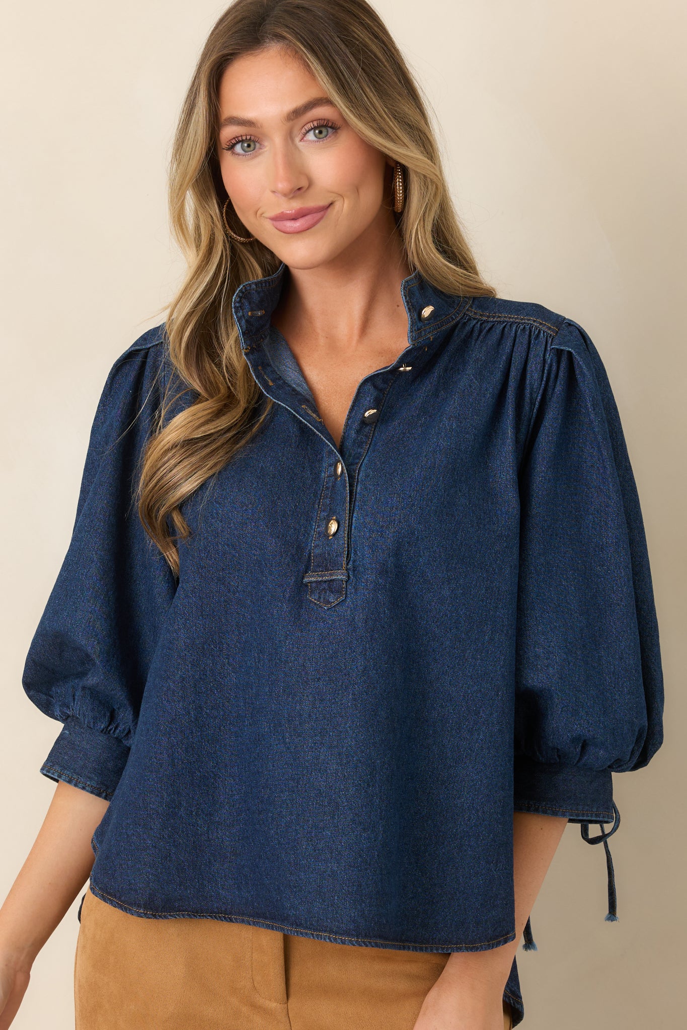 Cotton-blend denim texture complements the structured collar, button placket, and relaxed upper silhouette.