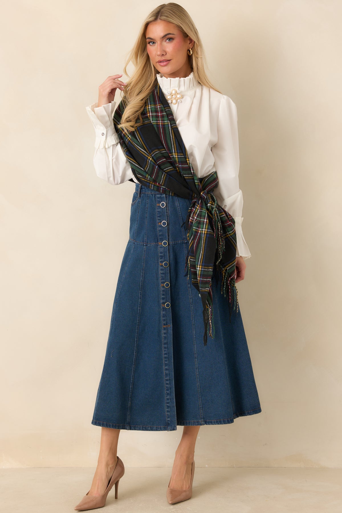 Cotton-blend denim skirt featuring paneled seams and a row of gold-tone framed buttons.