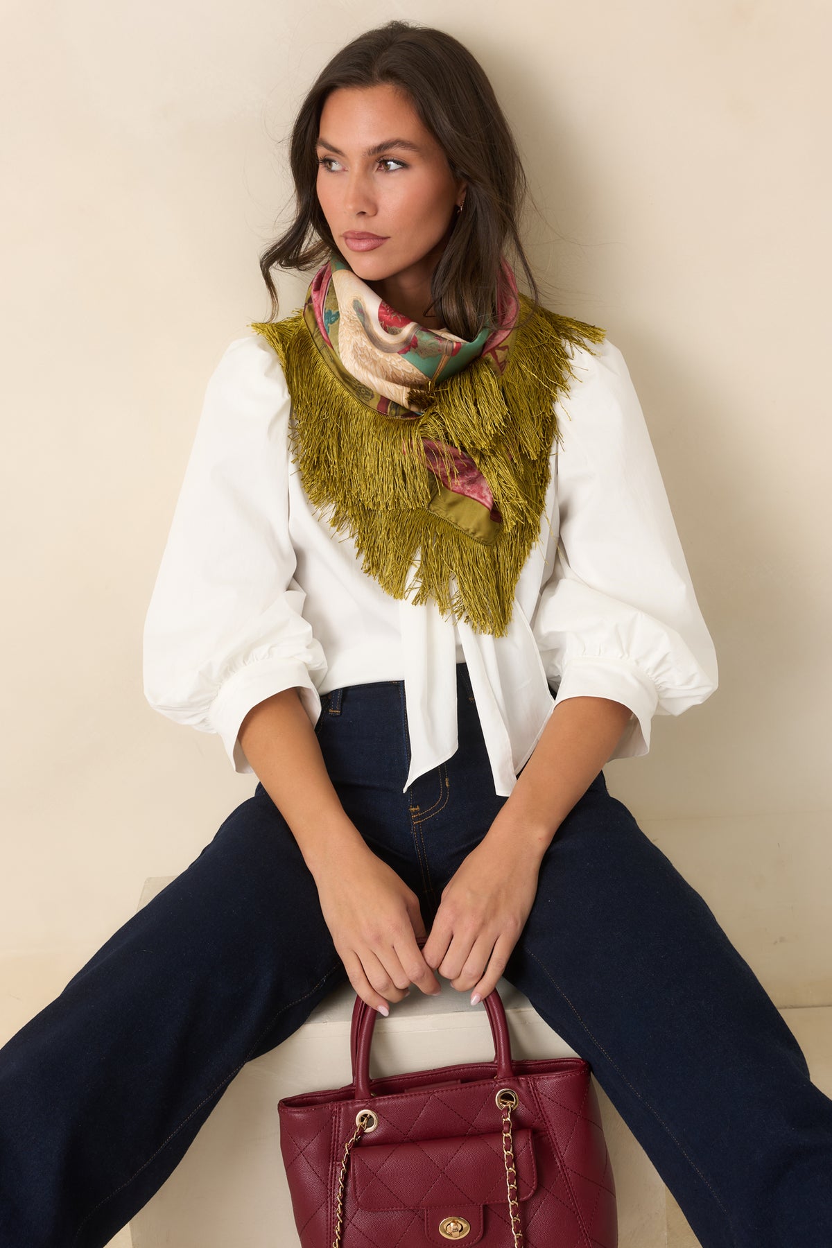 Relaxed cotton-blend blouse showcasing the sculptural gold-tone accent beneath the draped neck ties.