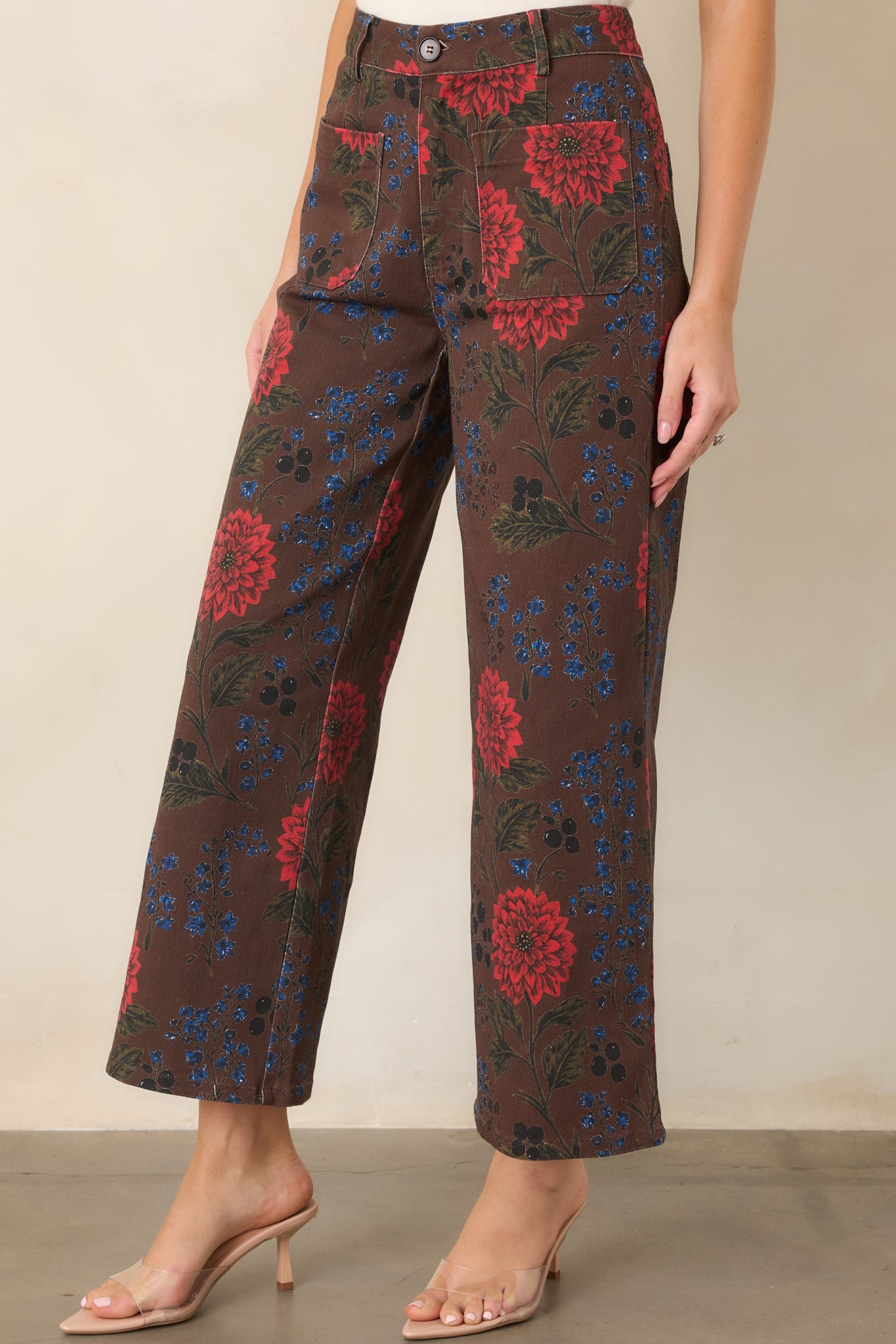 Cotton-blend pants feature structured construction, vibrant floral blooms, and a relaxed wide-leg silhouette.