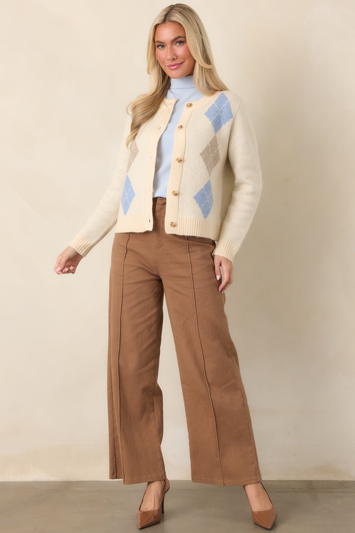 Stretch cotton-blend pants with a tailored high waist, neatly pressed pleats, relaxed leg shape, and clean finished hems.