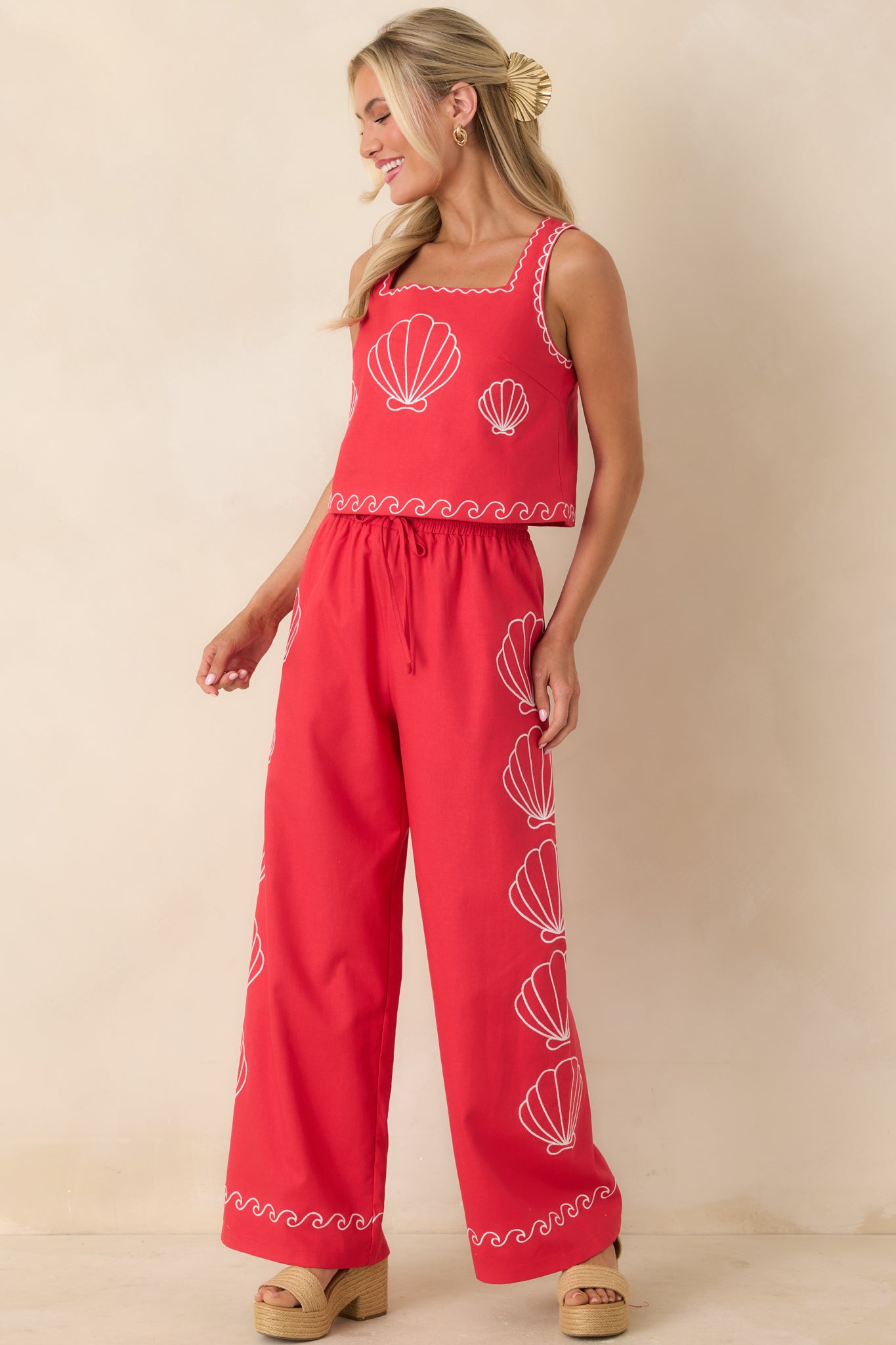 Cotton blend red pants featuring drawstring waist and easy movement.