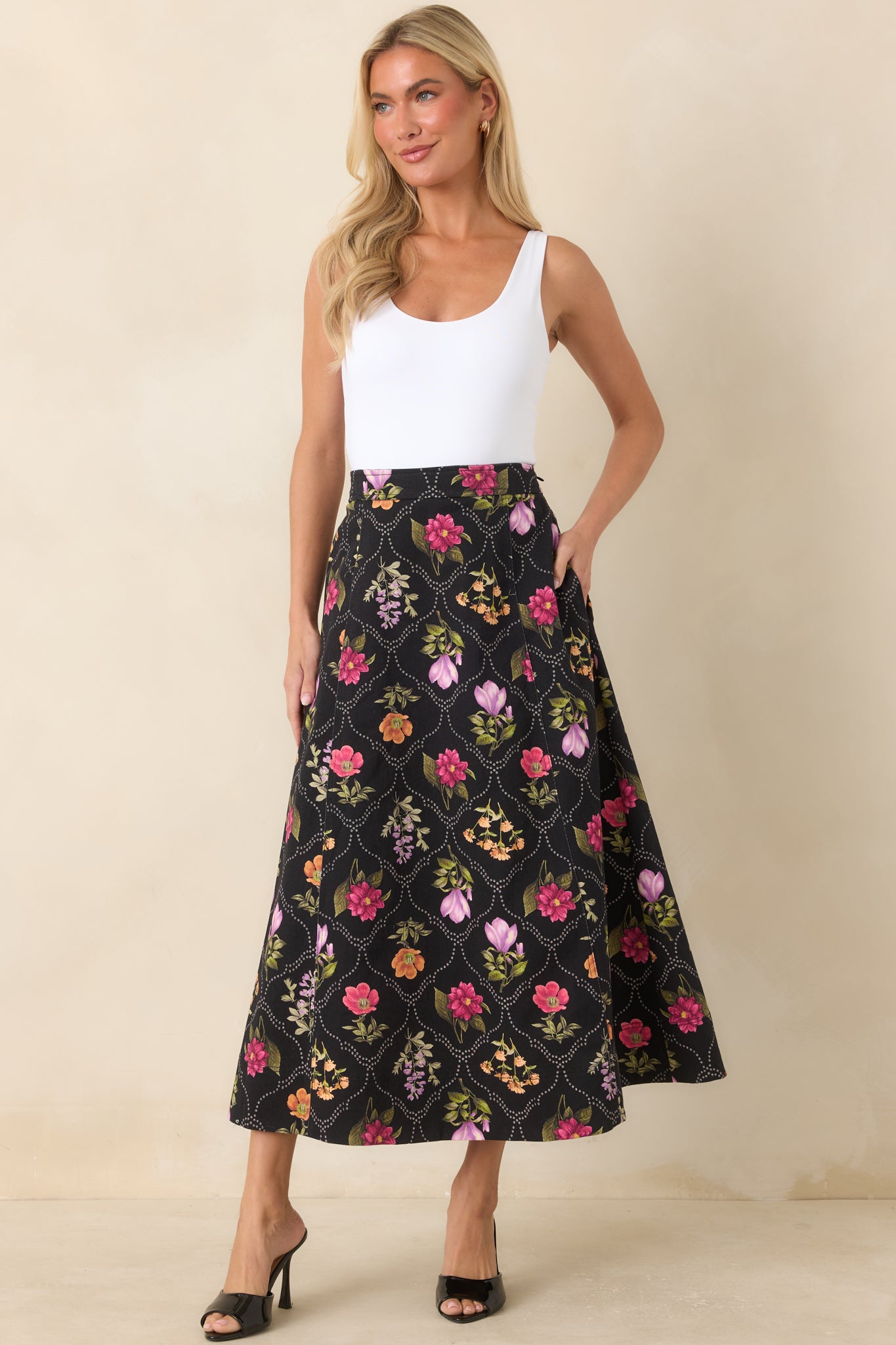 Cotton-blend skirt showcasing pink, purple, orange, and green florals within a dotted lattice design.