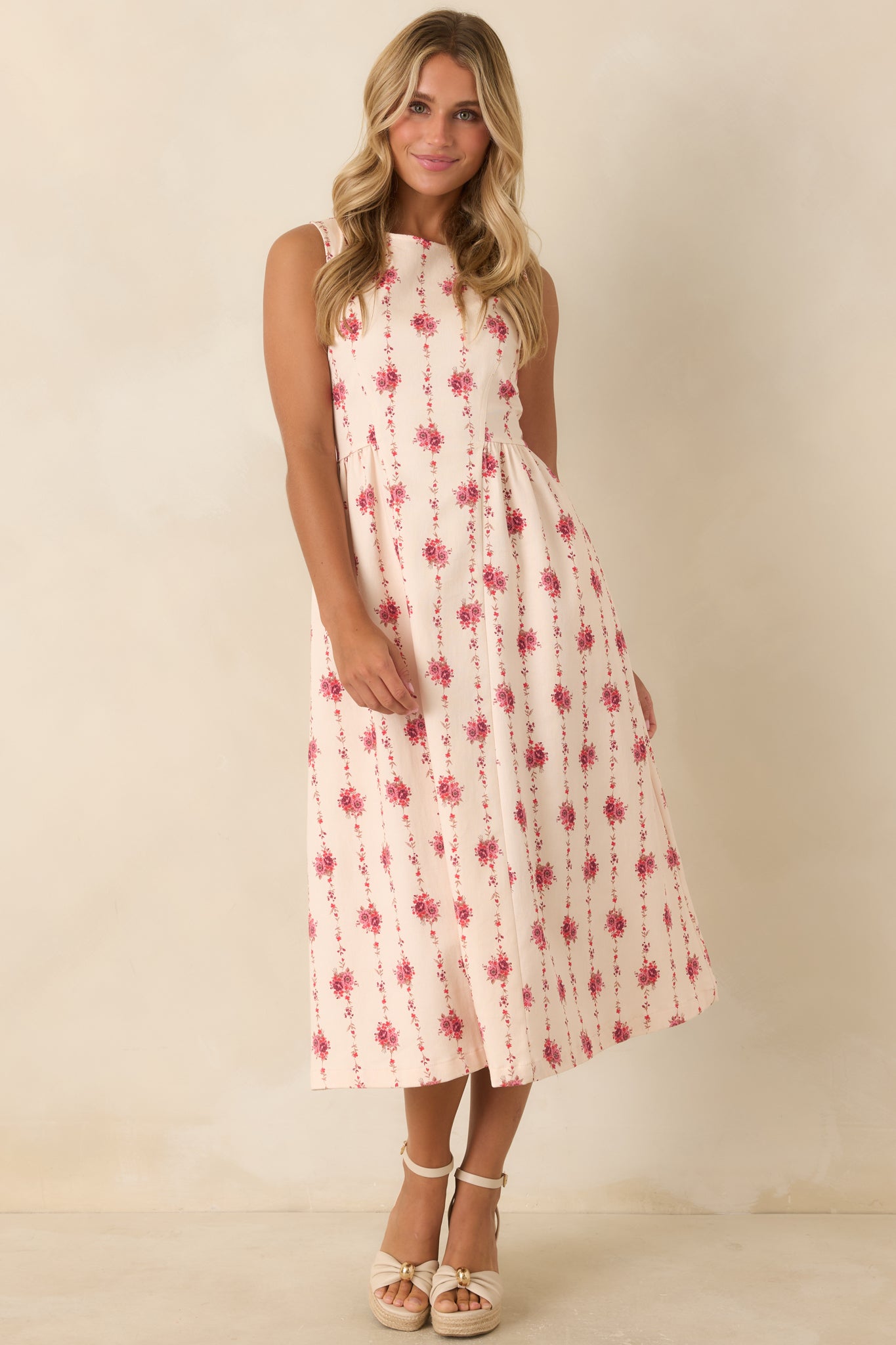 Cotton blend sleeveless midi dress featuring a structured silhouette, hidden pockets, floral stripe detailing, and elegant shaping.