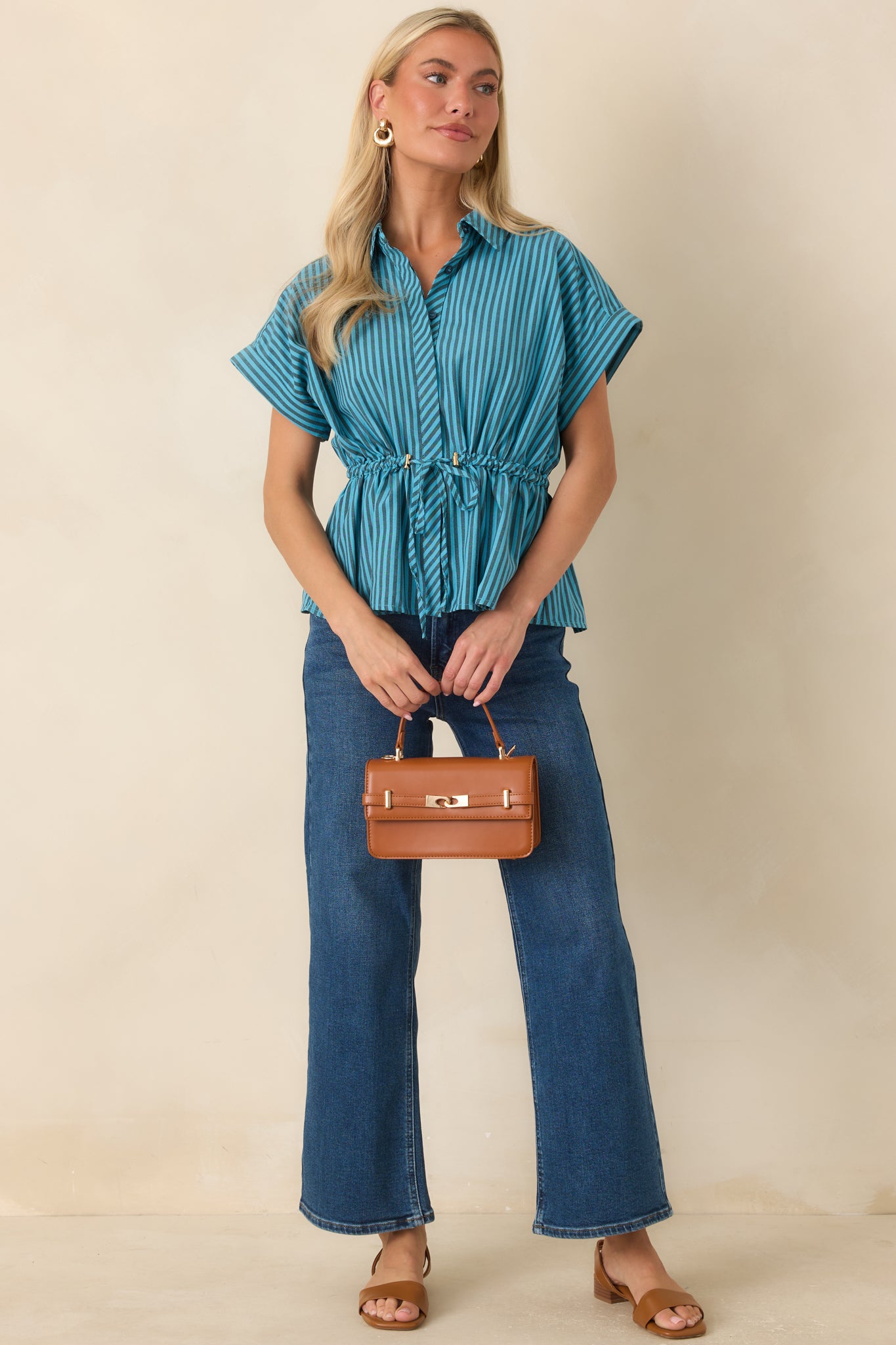 Cotton blend top with relaxed drop shoulders, cuffed sleeves, and polished gold-tone toggles.