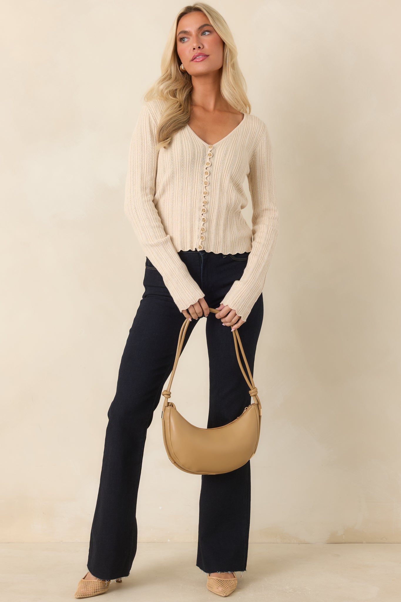 Soft cotton blend top with delicate ruffle trim and lightweight textured knit construction.