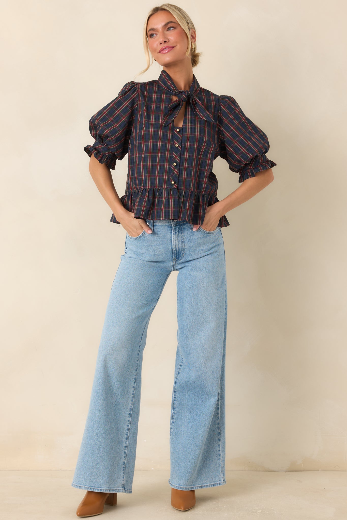 Cotton blouse featuring a self-tie neckline, puffed sleeves, ruffled cuffs, and a gathered peplum hem.