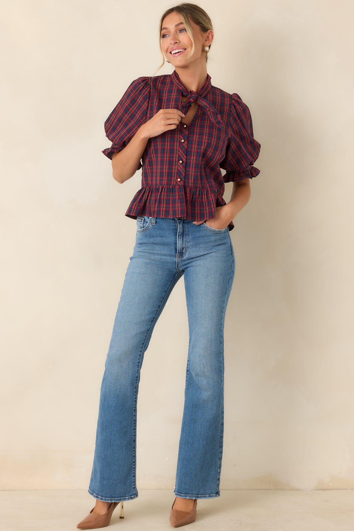 Cotton blouse featuring a self-tie neckline, puff sleeves, ruffled cuffs, and a gathered peplum hem.