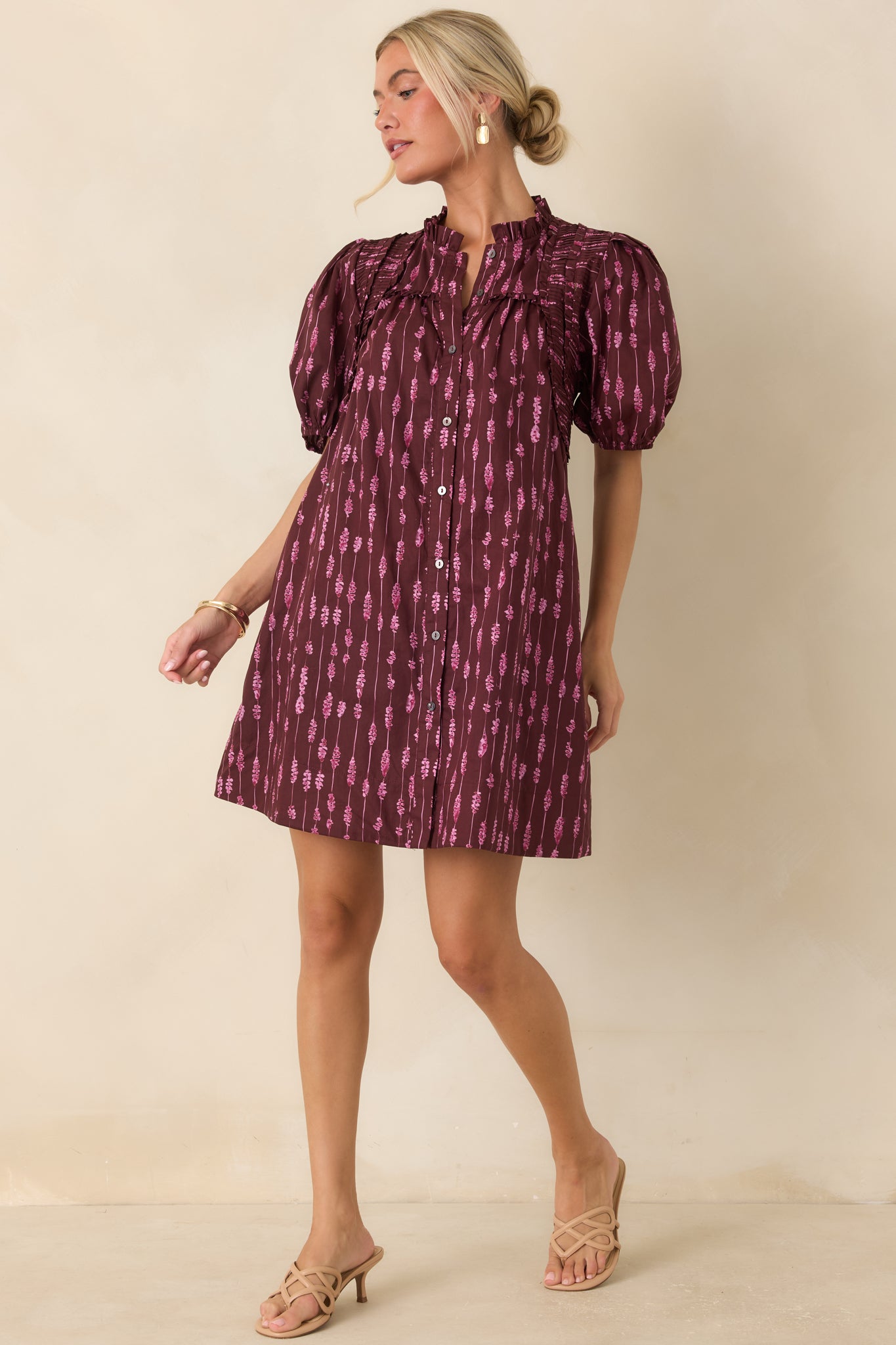 Cotton button-front mini dress designed with pintucked shoulder detailing, elasticized sleeve cuffs, and a feminine striped pattern.